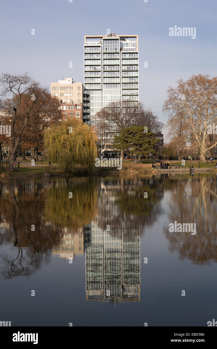 Buildings reflected on the surface of the Harlem Meer (lake) in Central Park, New York City. Stock Photo
