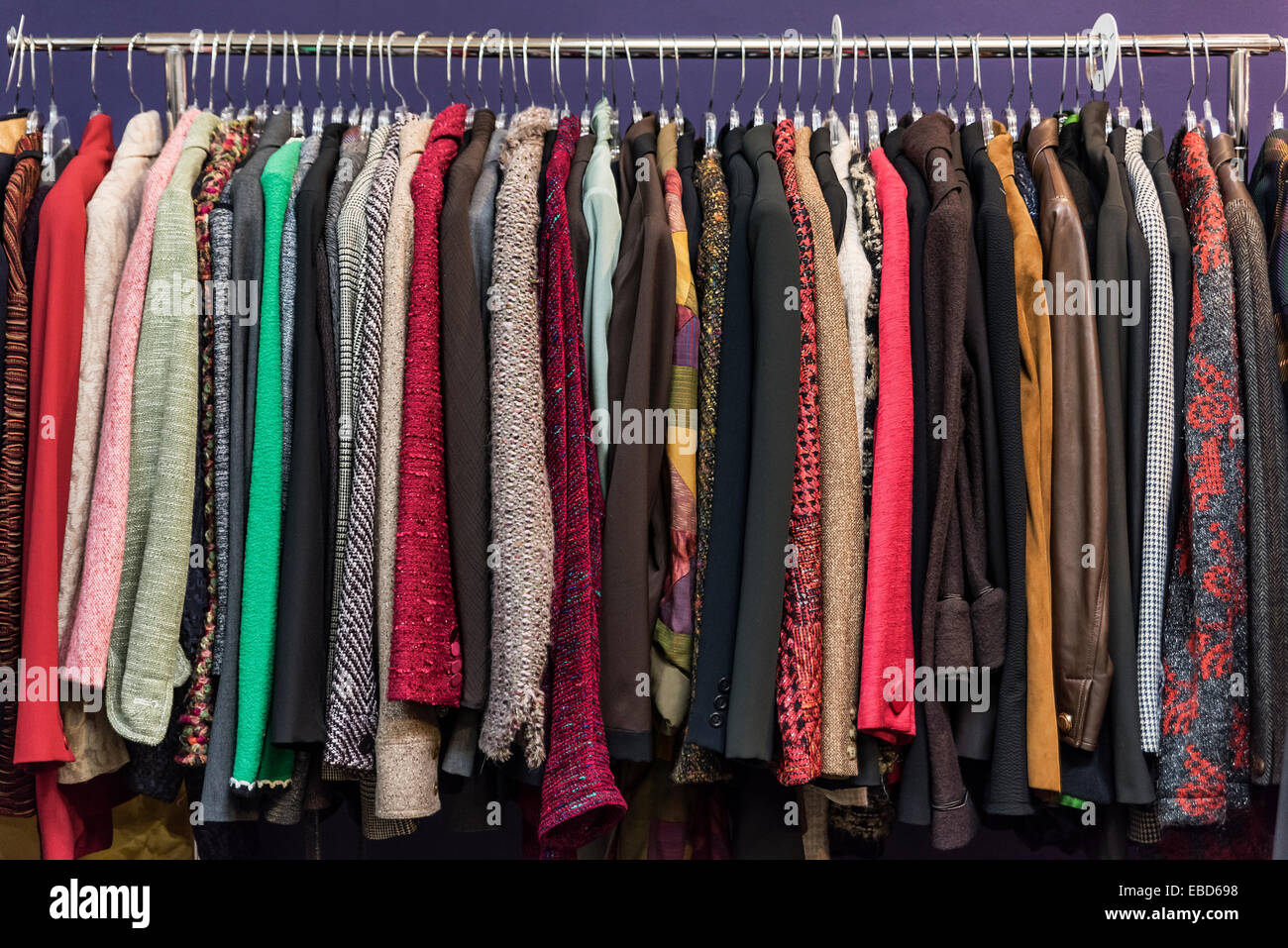 Women's jacket selection in a thrift shop. Stock Photo