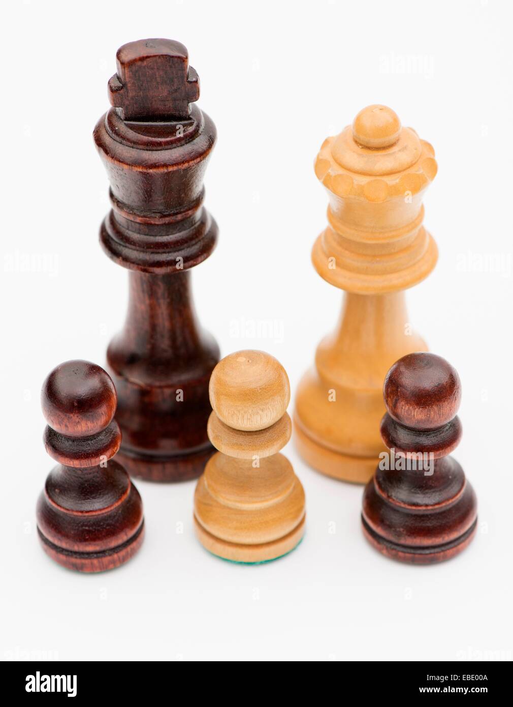 Studio shot of chess pieces symbolising family with mixed ethnic background. Stock Photo