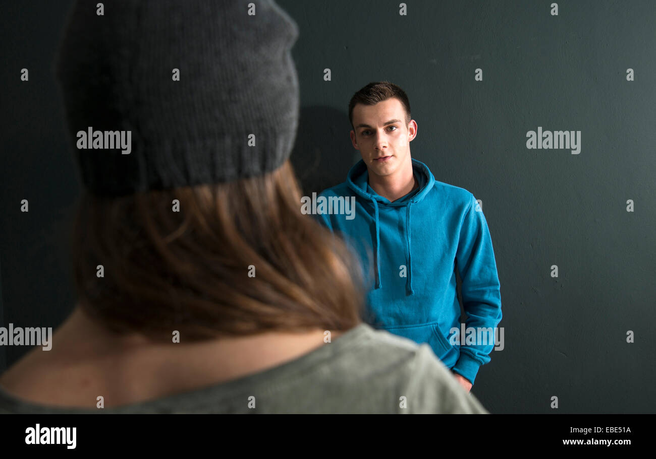 Teenage Girl and Young Man Talking, Studio Shot Stock Photo