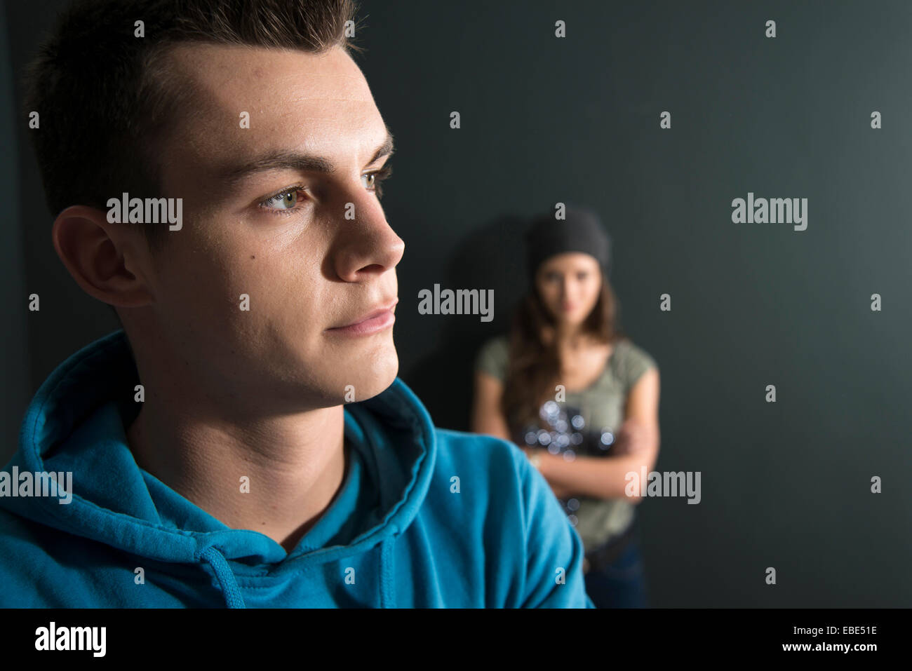 Teenage Girl and Young Man Arguing, Studio Shot Stock Photo