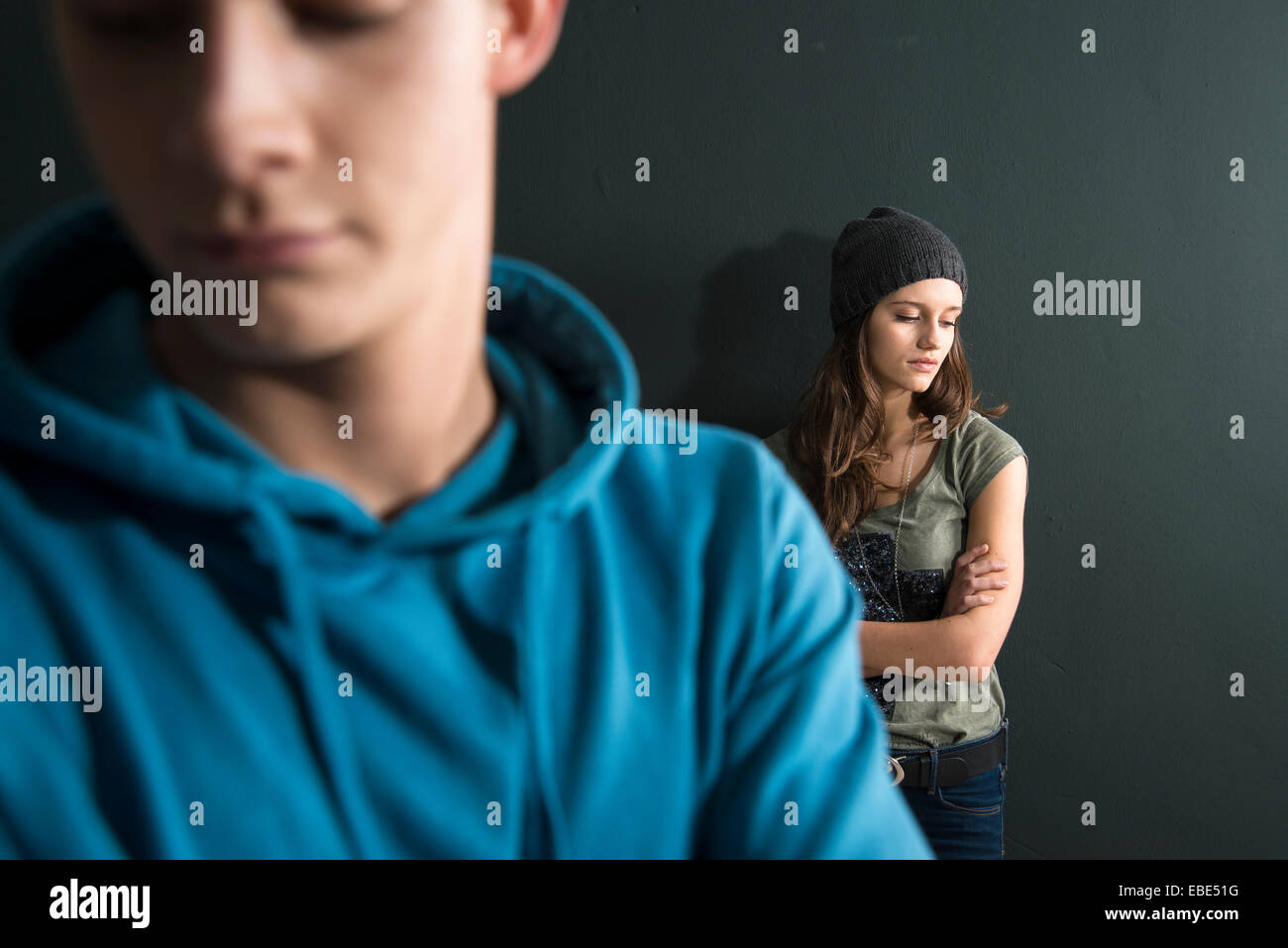 Teenage Girl and Young Man Arguing, Studio Shot Stock Photo