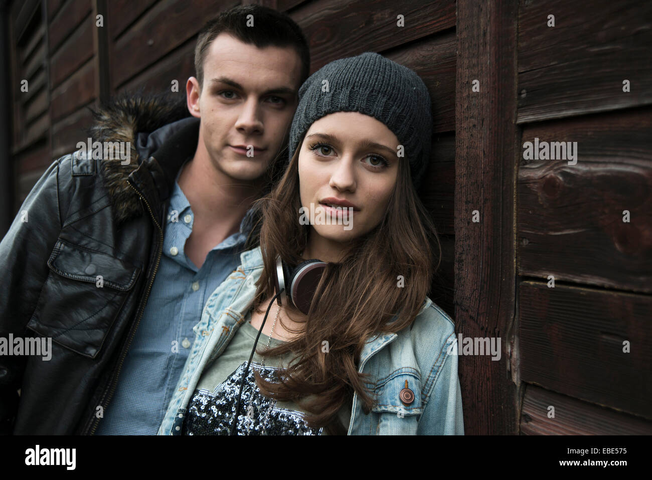 Close-up portrait of teenage girl and young man outdoors, looking at ...
