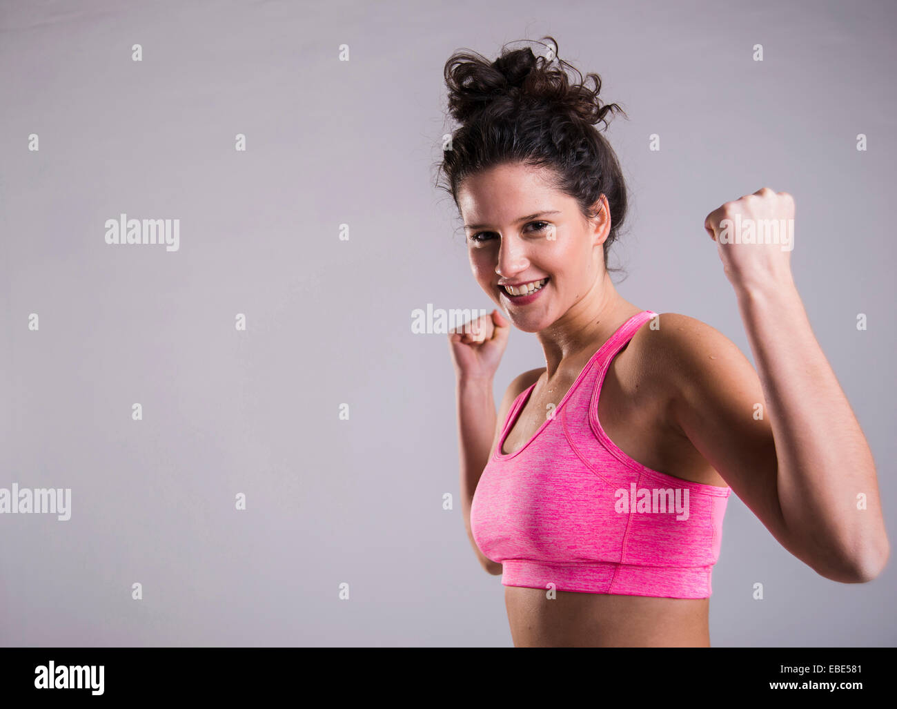 Young brunette flexing body at sport ground Stock Photo - Alamy
