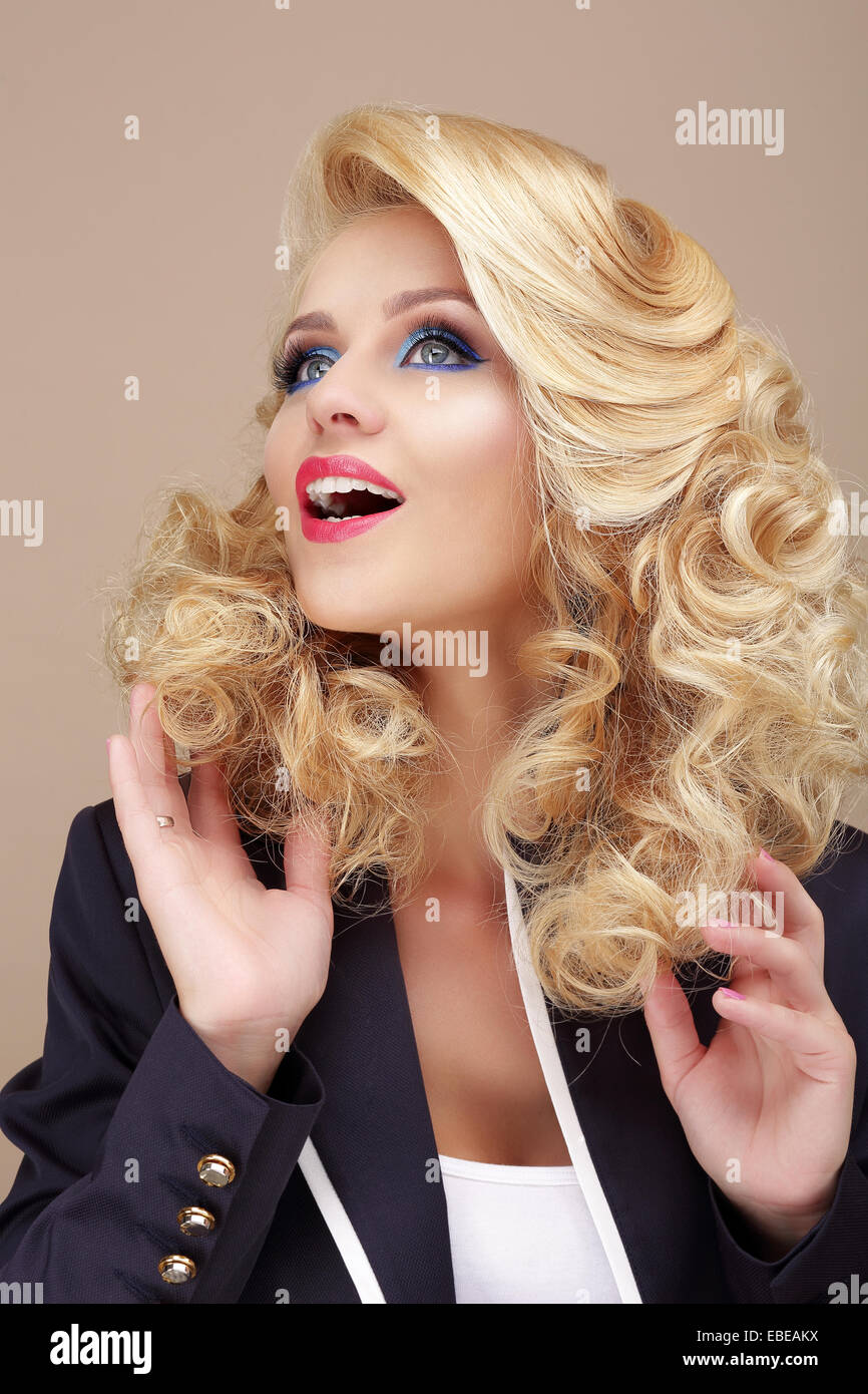 Astonishment. Surprised Blond Woman Looking Up Stock Photo