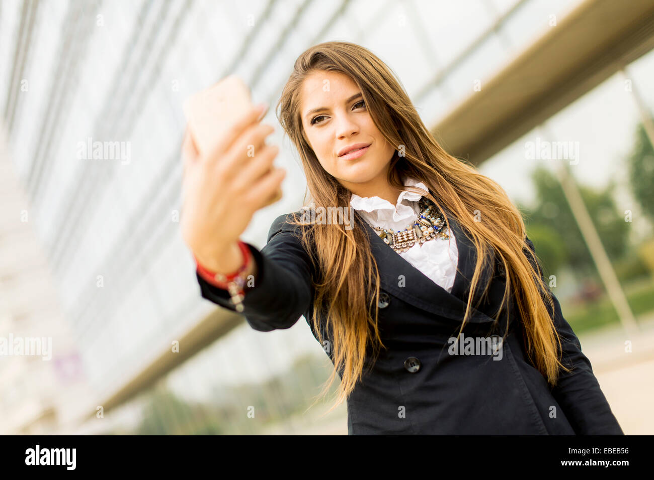 Young woman taking a selfie with mobile phone Stock Photo - Alamy