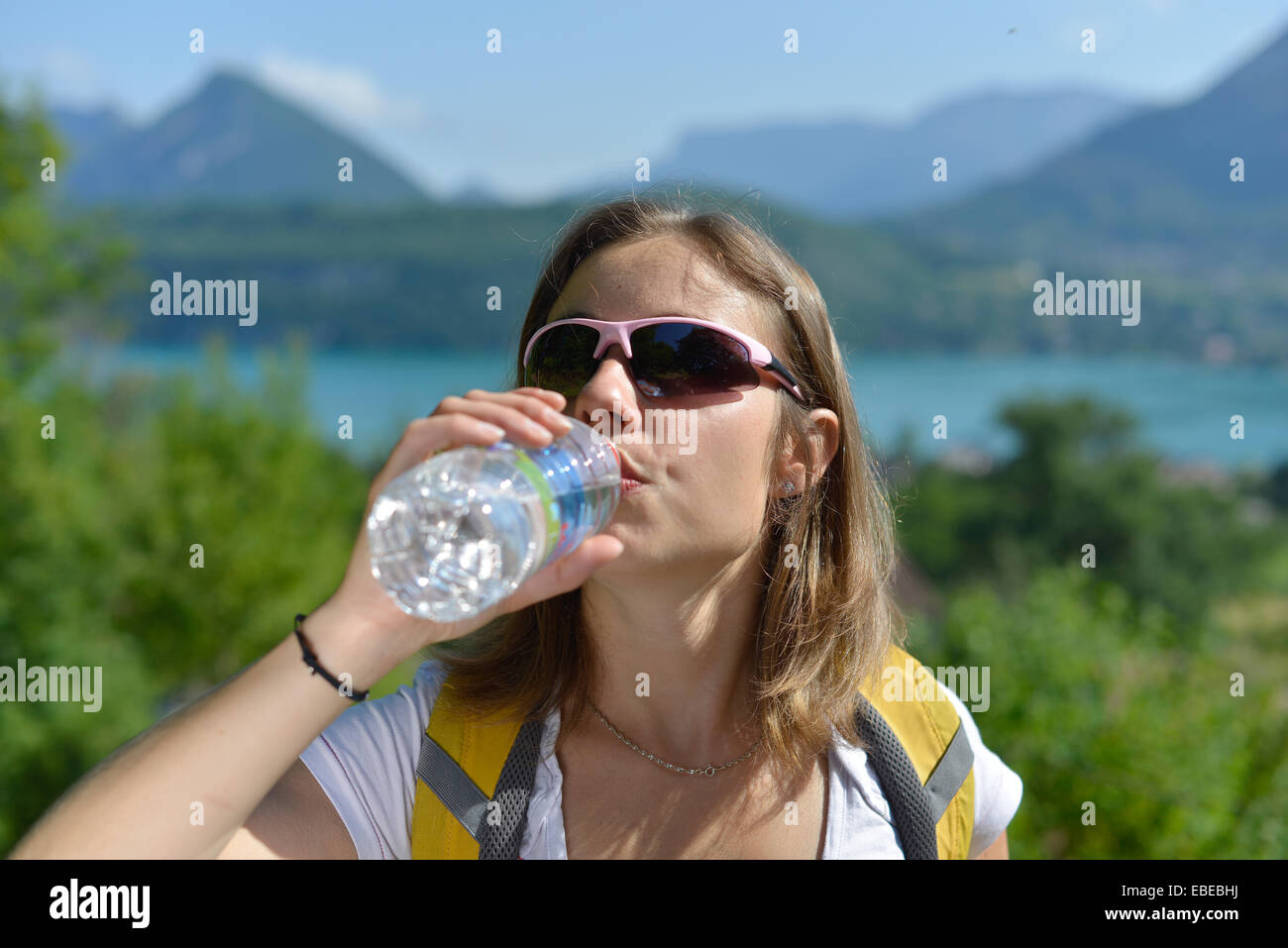 pretty young woman is resting during a hike in the French Alps Stock ...