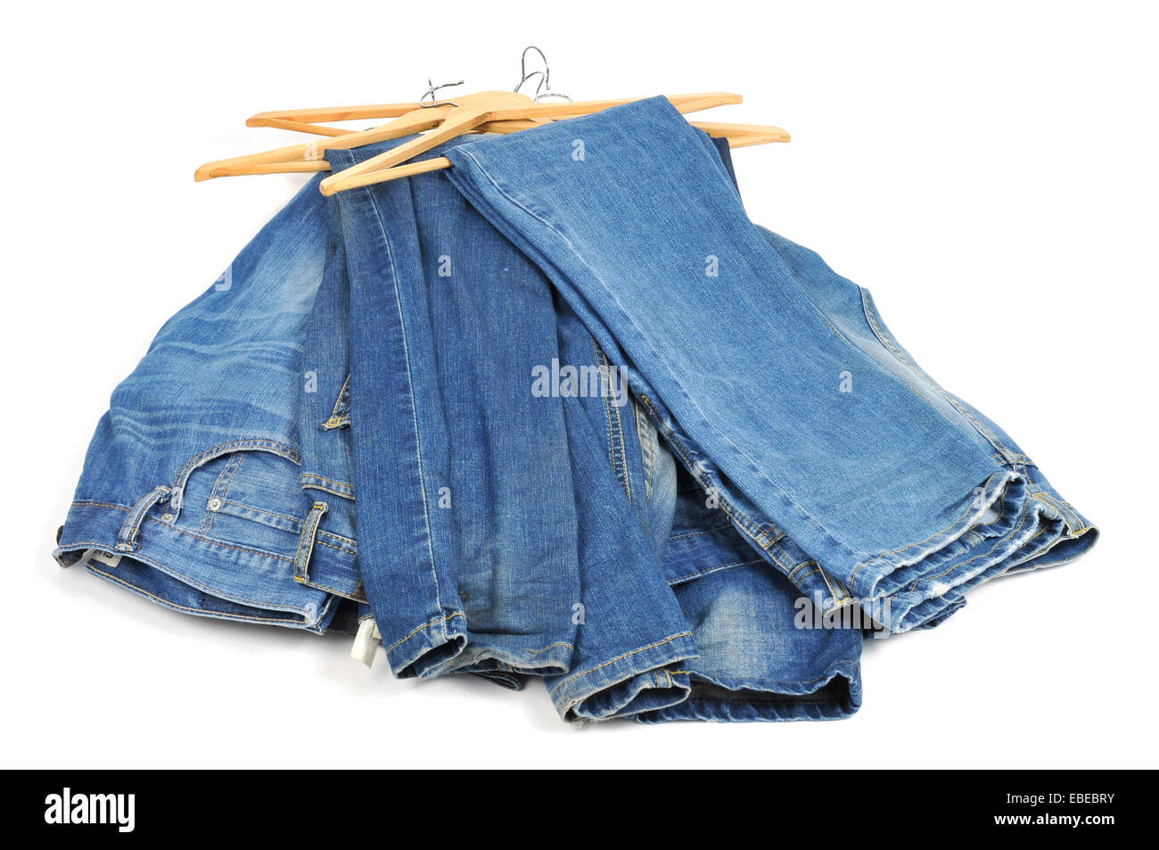 some blue jeans in wooden clothes hangers on a white background Stock Photo Alamy