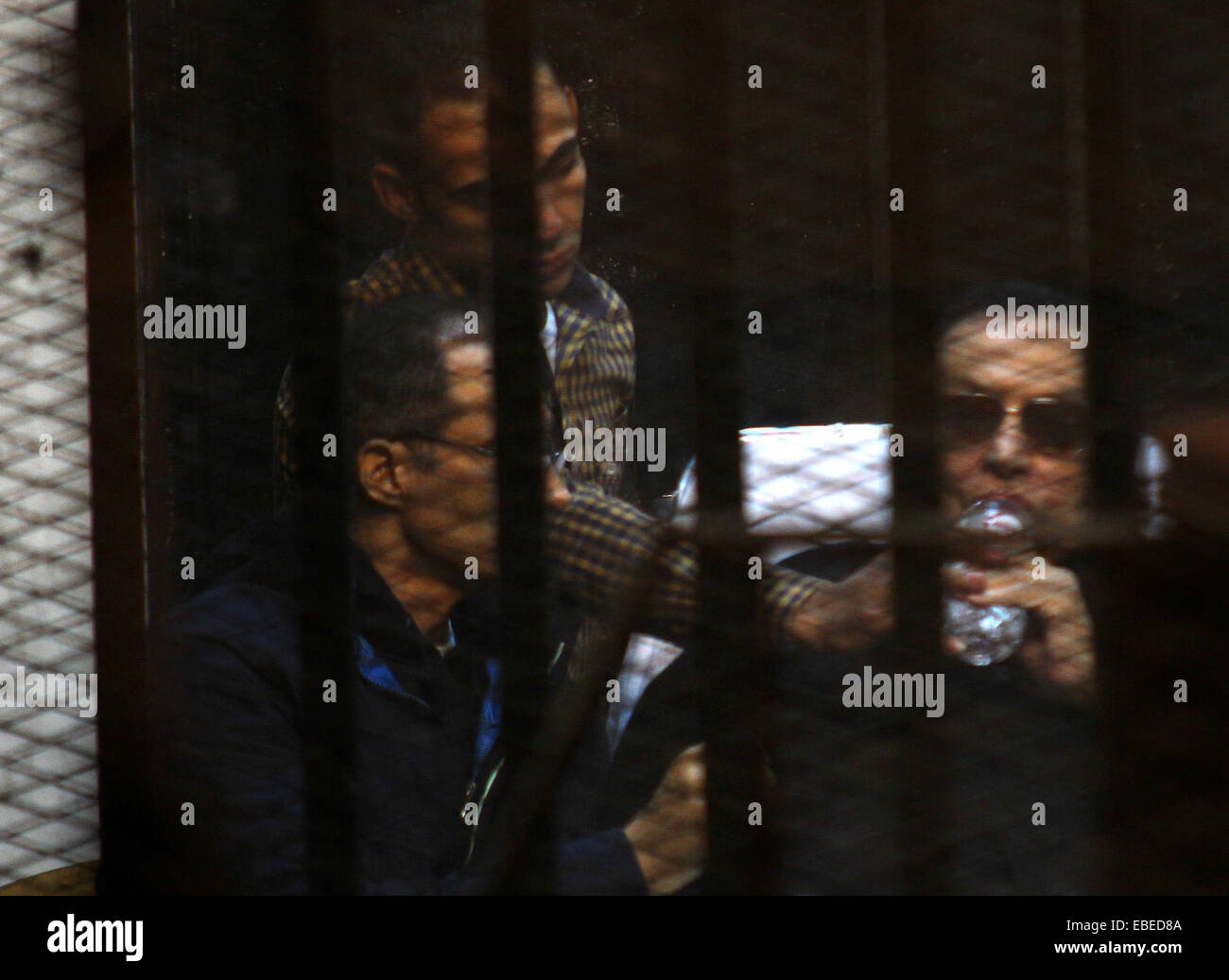 Cairo, Egypt. 29th Nov, 2014. Egypt's former president Hosni Mubarak with his son Gamal Mubarak are seen inside the court in Cairo, Egypt, Nov. 29, 2014 after a court dismissed a murder charge against the ousted leader over the deaths of protesters during a 2011 uprising that ended the former strongman's decades-long rule. The court also acquitted Mubarak of a corruption charge, but he will remain in prison because he is serving a three-year sentence in a separate corruption case © Stringer/APA Images/ZUMA Wire/Alamy Live News Stock Photo
