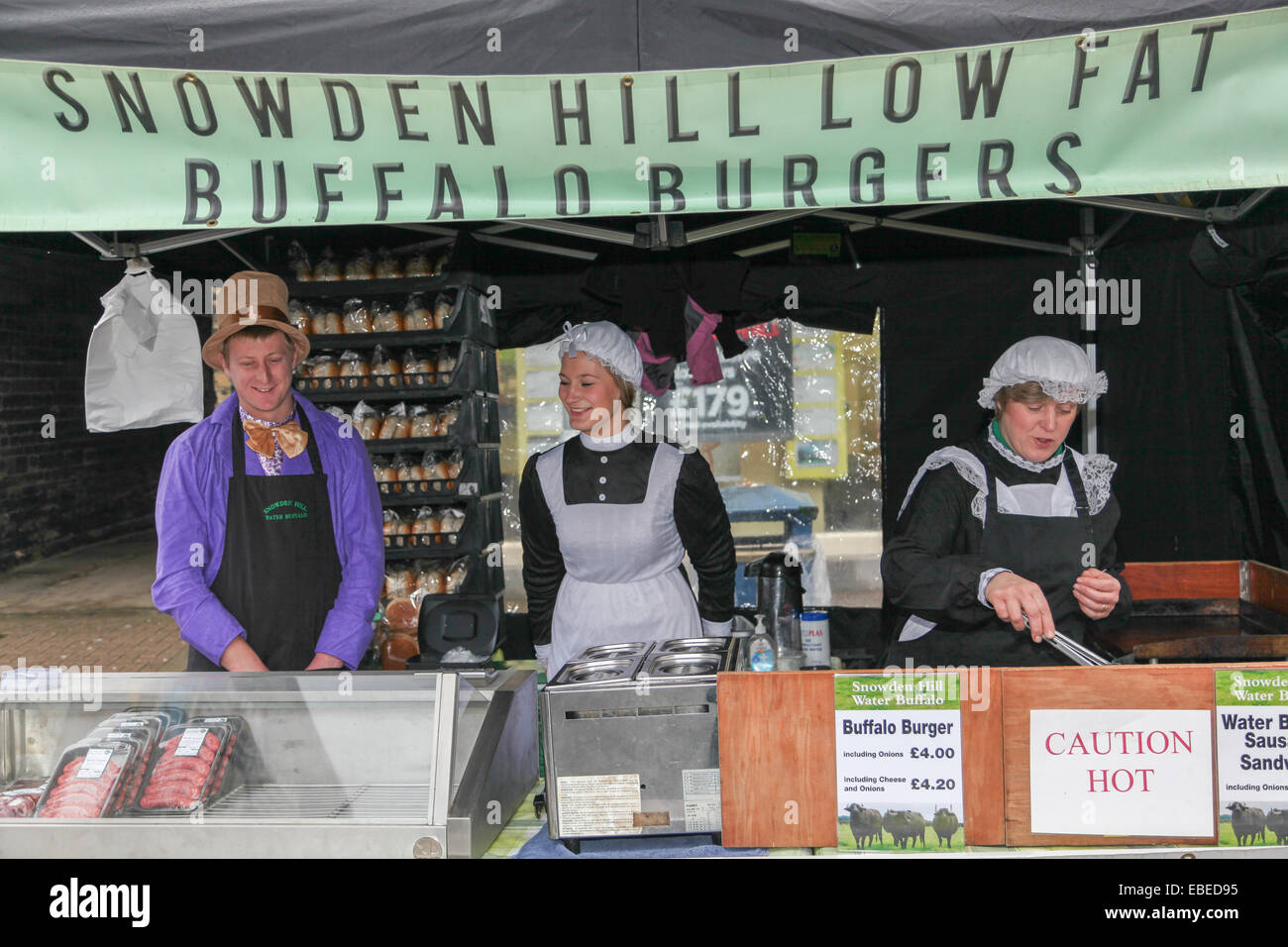 Brighouse, West Yorkshire, United Kingdom. November 29th, 2014. Victorian Christmas market.Vendors in period costume selling snowden hill low fat buffalo burgers. Stock Photo