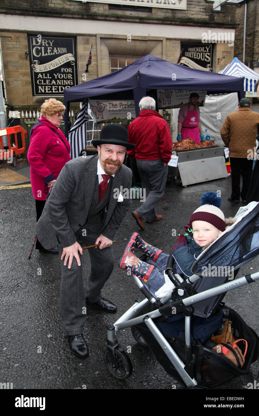 Brighouse, West Yorkshire, United Kingdom. November 29th, 2014. Victorian Christmas market. Magician and entertainer, Alexander Wells engages with a young spectator. Credit:  Mick Flynn/Alamy Live News Stock Photo