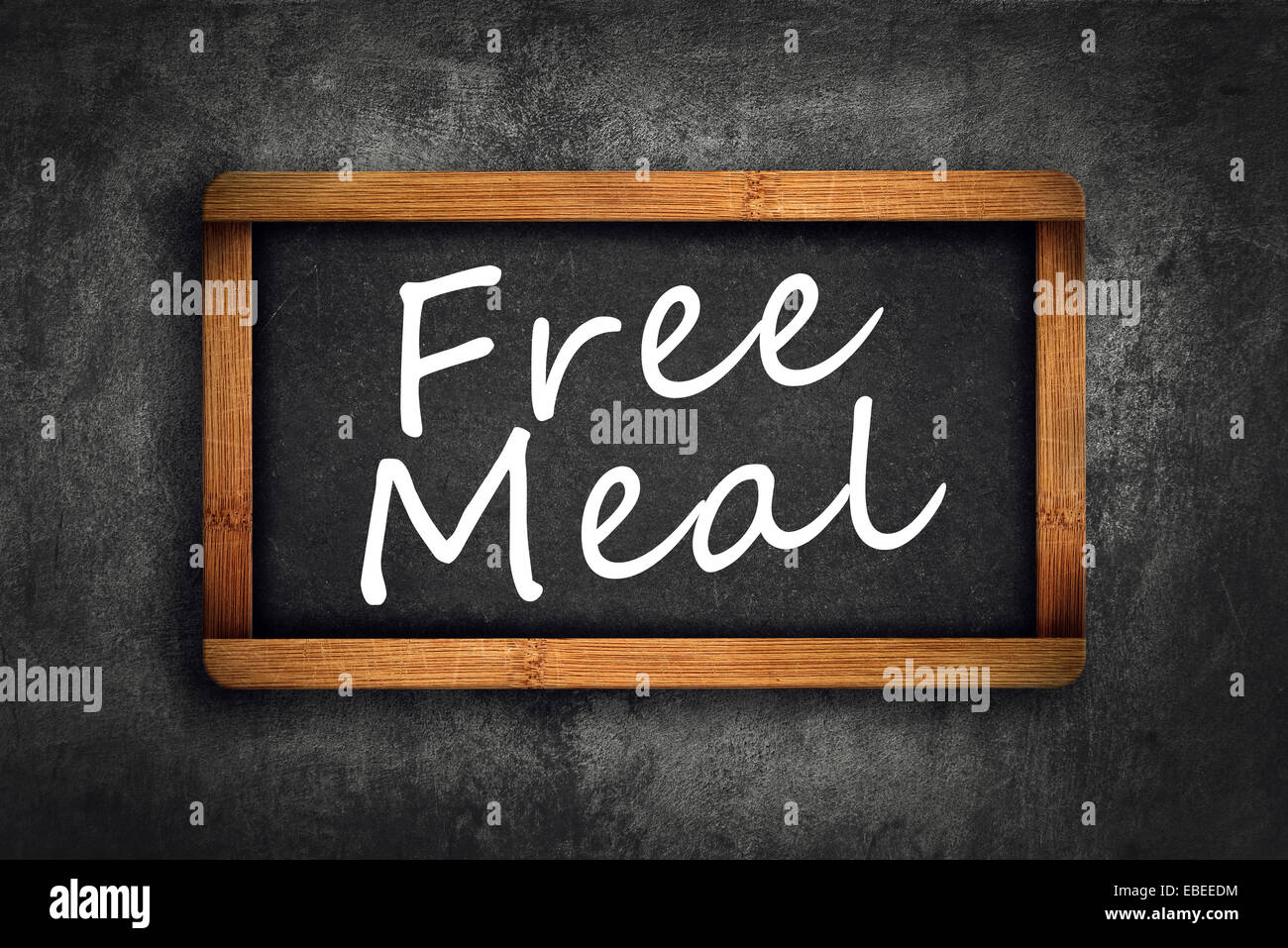 Free Meal Title in white chalk on Restaurant Blackboard. Stock Photo