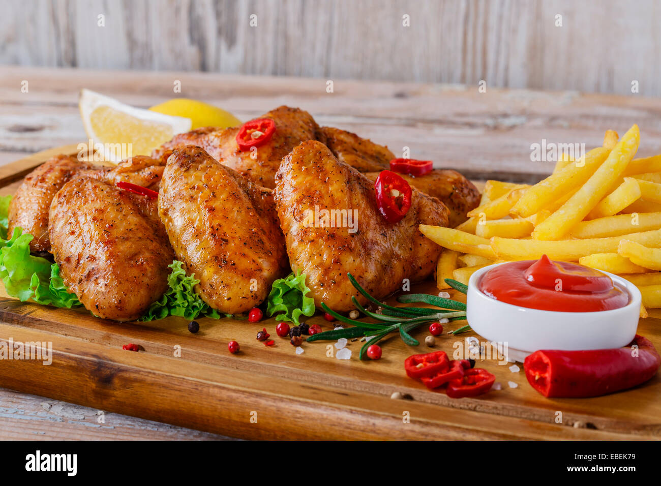 fried chicken wings with red sauce and French fries Stock Photo - Alamy