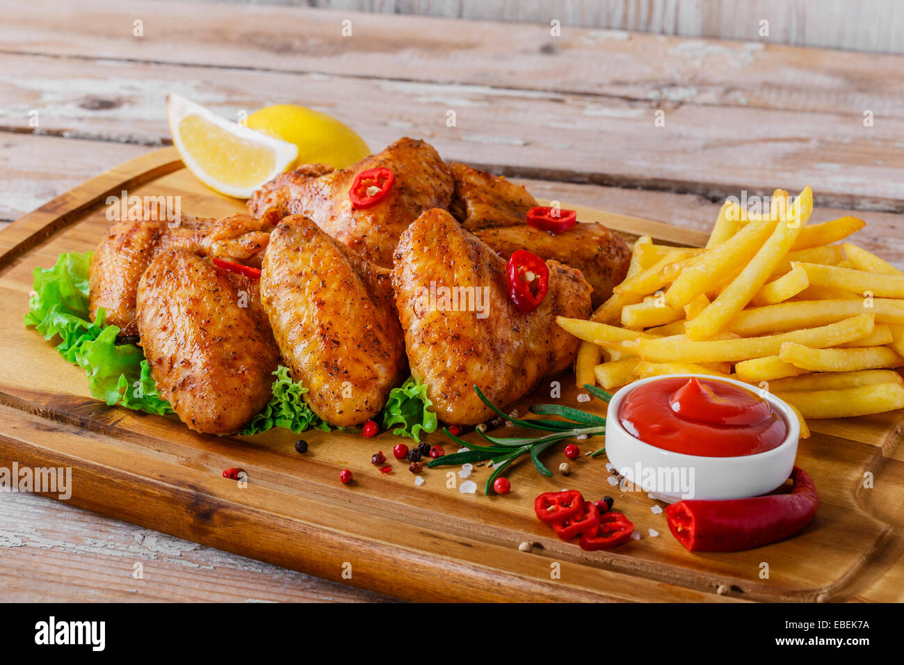 fried chicken wings with red sauce and French fries Stock Photo