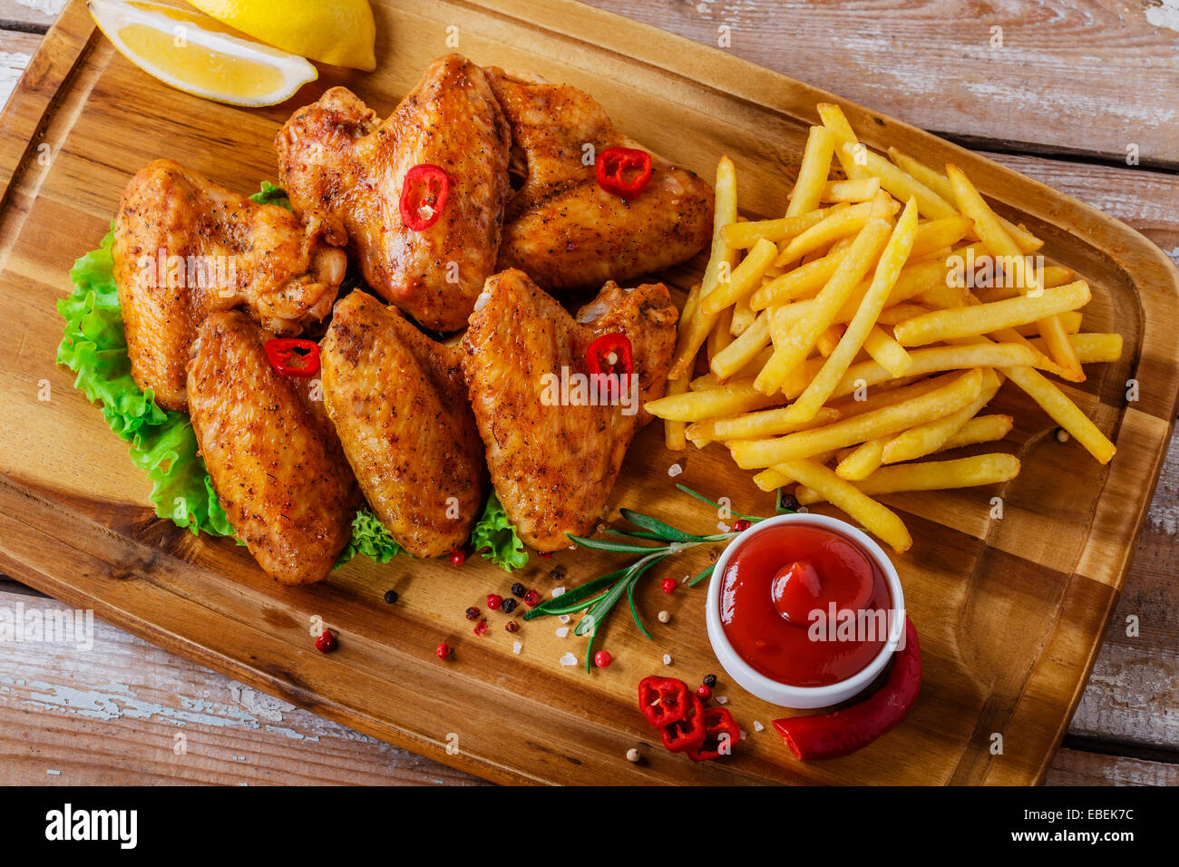 fried chicken wings with red sauce and French fries Stock Photo