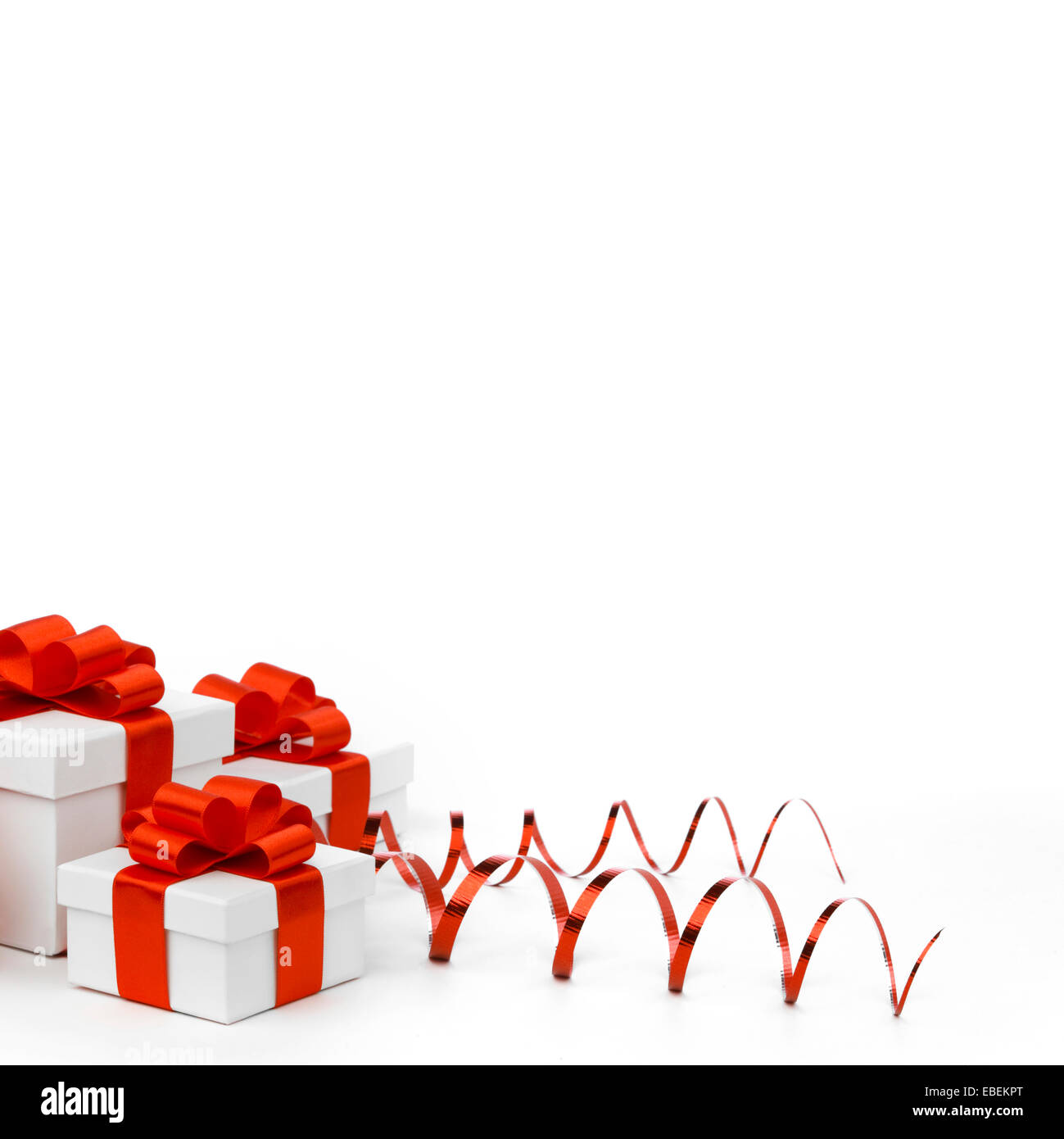 White gift boxes with red ribbon bows isolated on white background ...