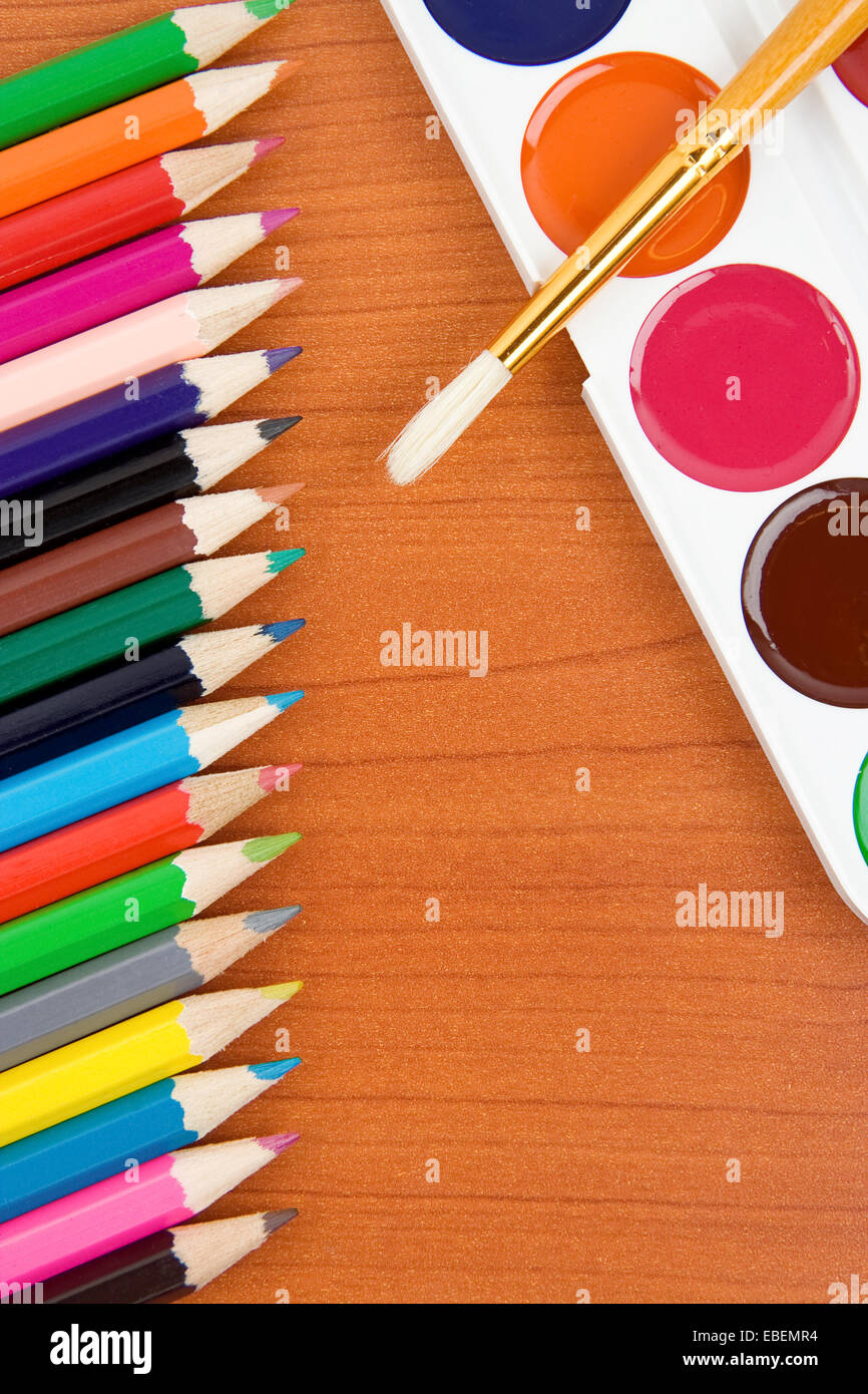 painters palette with brush and colorful pencils Stock Photo Alamy