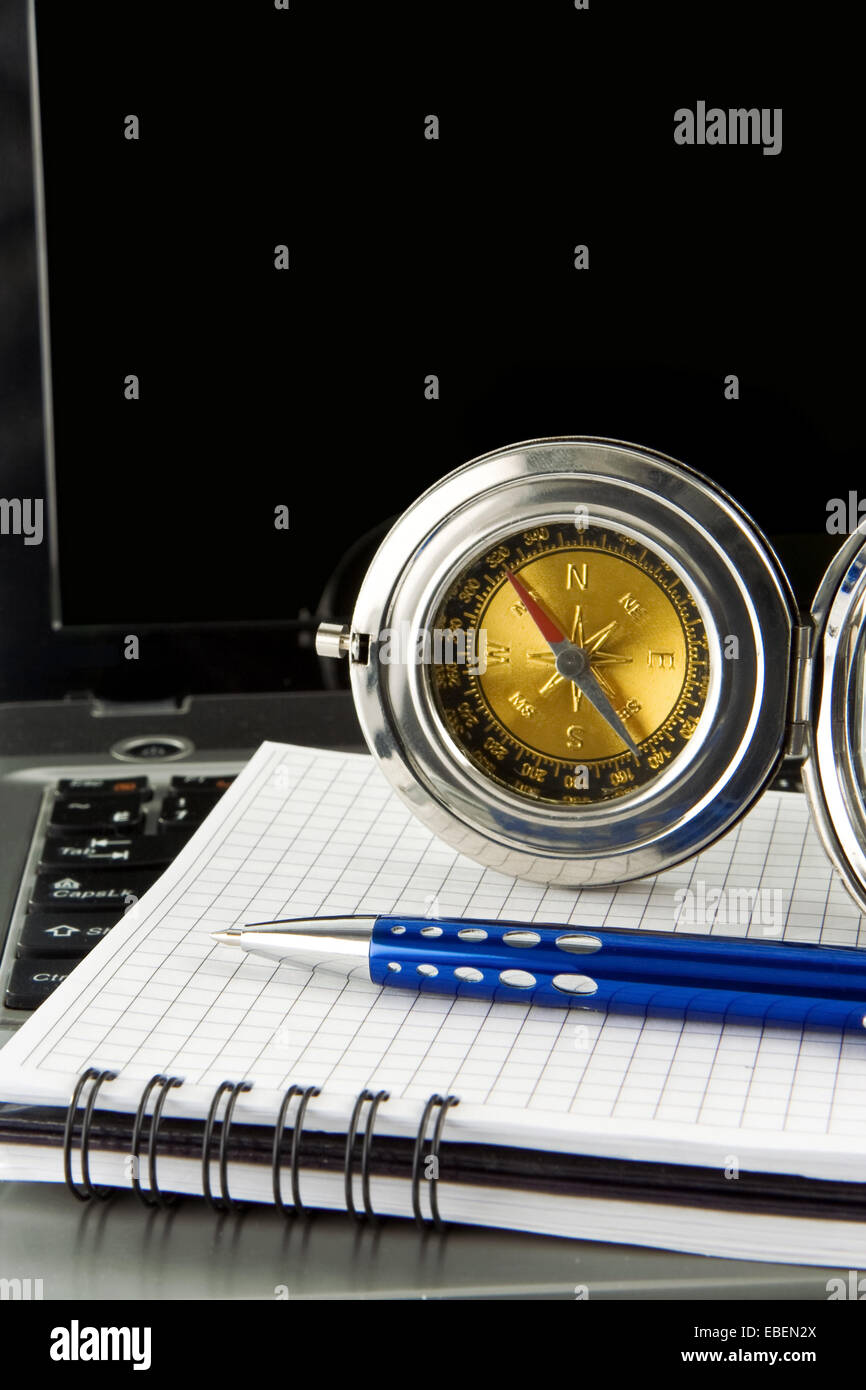 pen and gold compass on notebook laptop Stock Photo Alamy