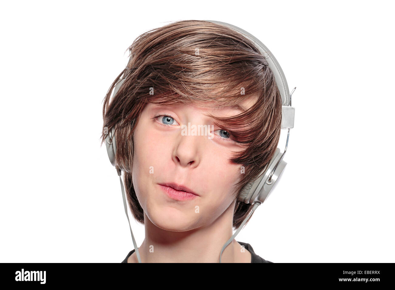lucky teenage boy with headphones, isolated on white Stock Photo