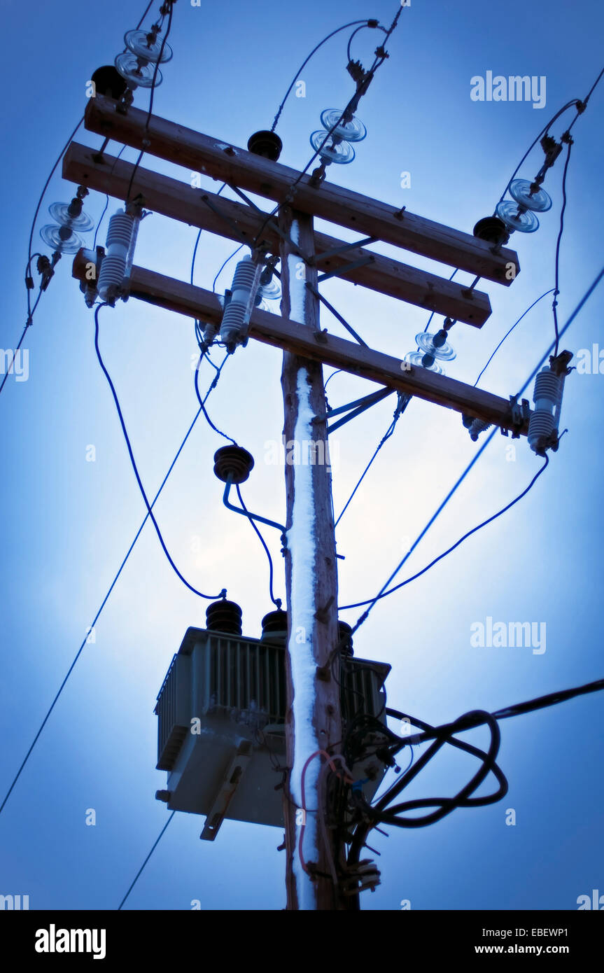 Detail of a snow-covered electricity pylon against sky Stock Photo