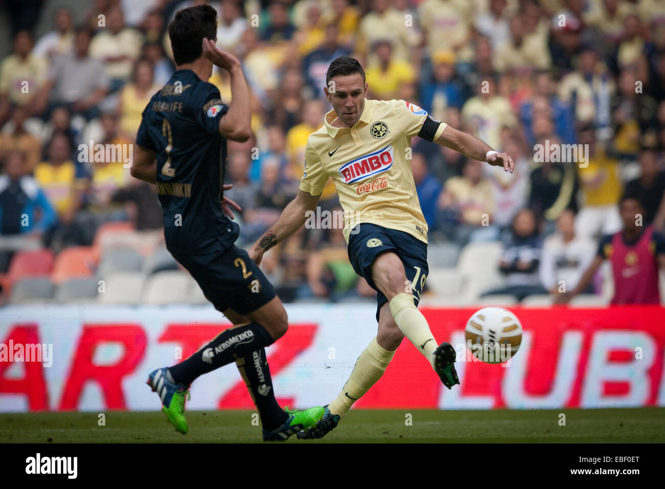 Mexico City, Mexico. 29th Nov, 2014. Miguel Layun (R) of America kicks the ball in front of Josecarlos Van Rankin of UNAM's Pumas during the quarterfinal match of Opening Tournament of the MX League, at Aztec Stadium, in Mexico City, capital of Mexico, on Nov. 29, 2014. © Pedro Mera/Xinhua/Alamy Live News Stock Photo