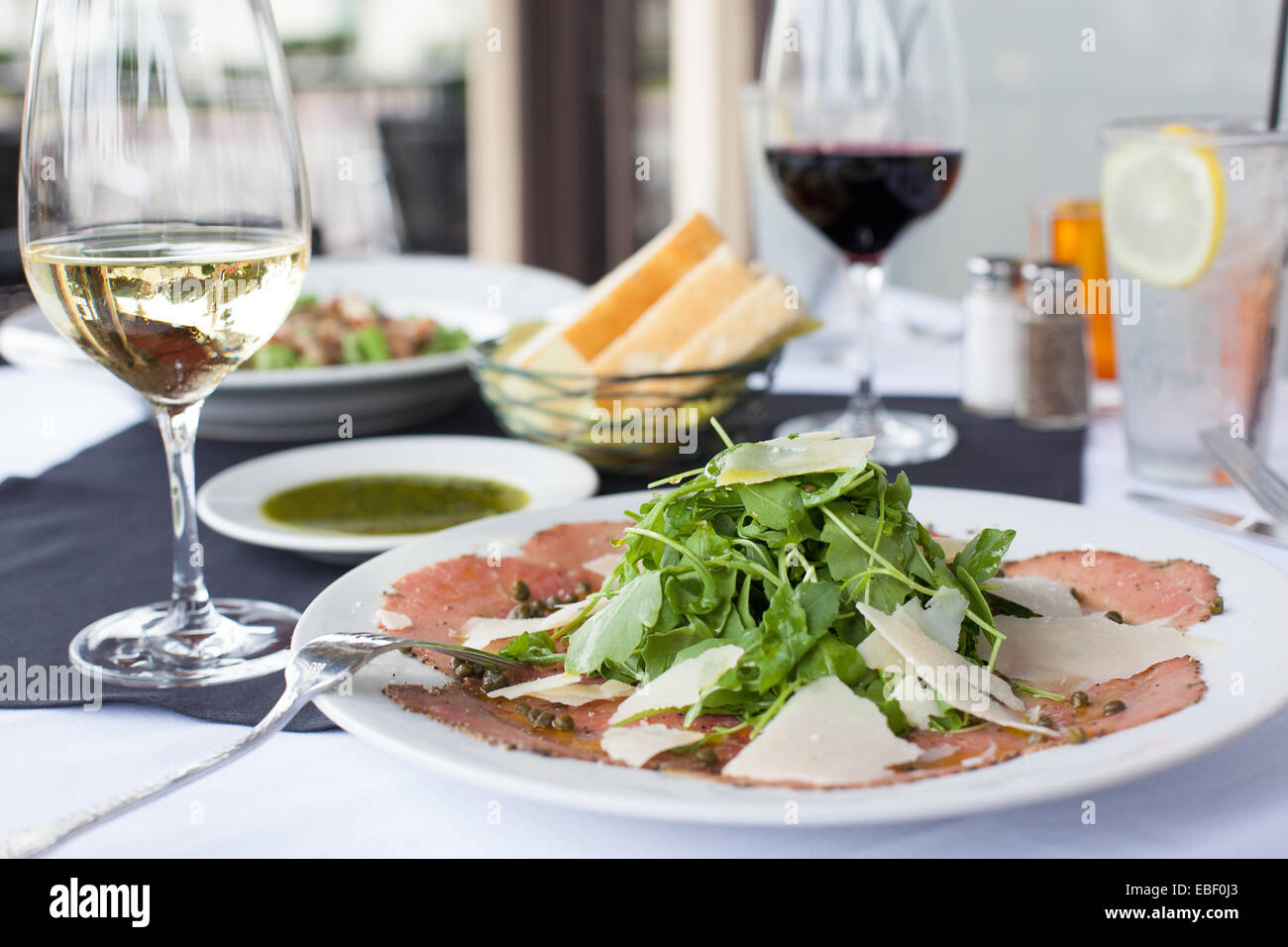 Italian meal outside on a patio with wine Stock Photo