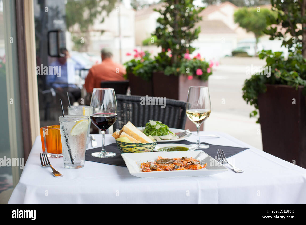 Patio table at a cafe with italian meal Stock Photo
