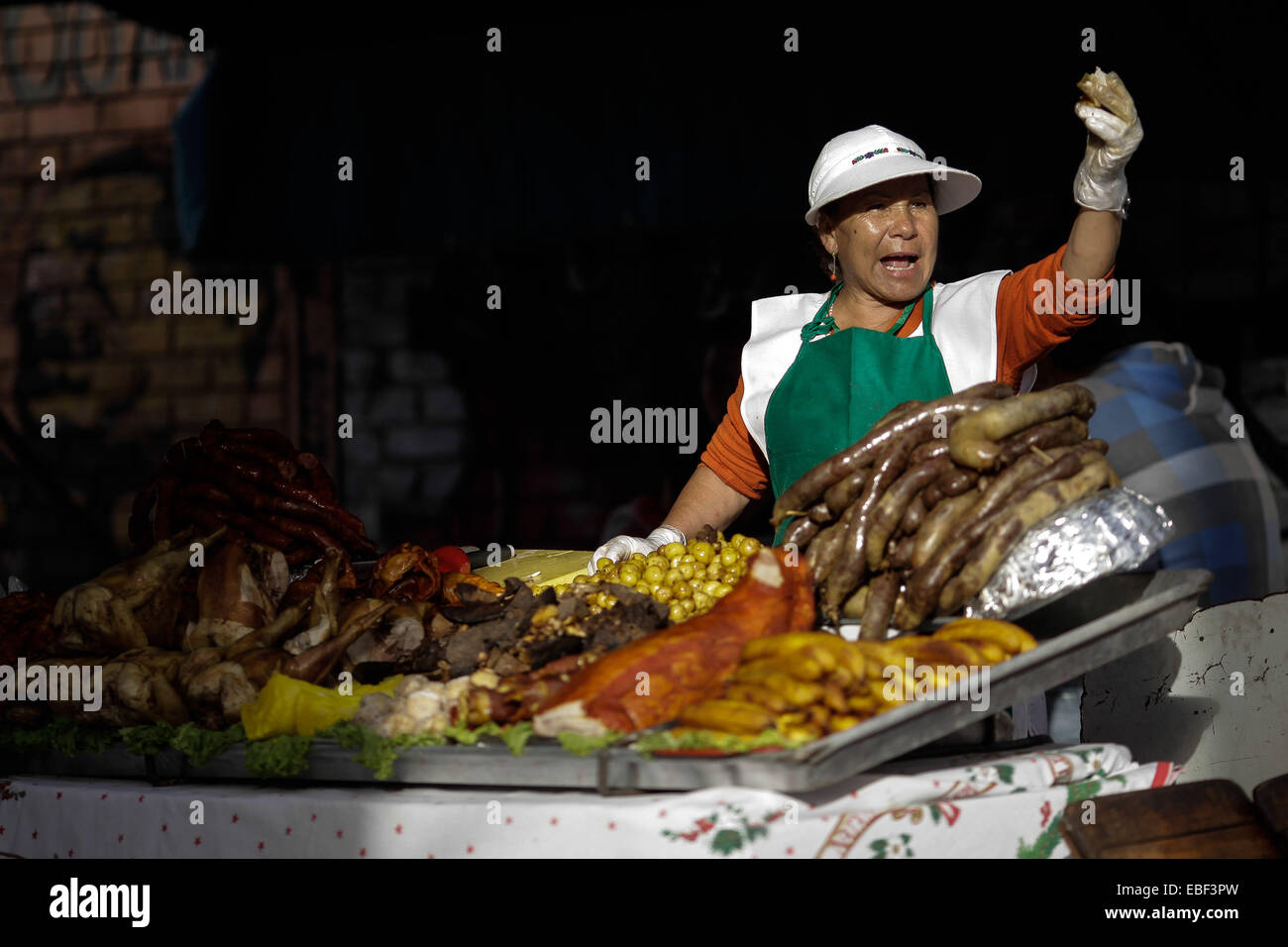 Bogota, Colombia. 29th Nov, 2014. A woman sells food during the 18th Chicha and Corn Festival, in Bogota, capital of Colombia, on Nov. 29, 2014. The chicha comes from the fermentation of corn. © Jhon Paz/Xinhua/Alamy Live News Stock Photo