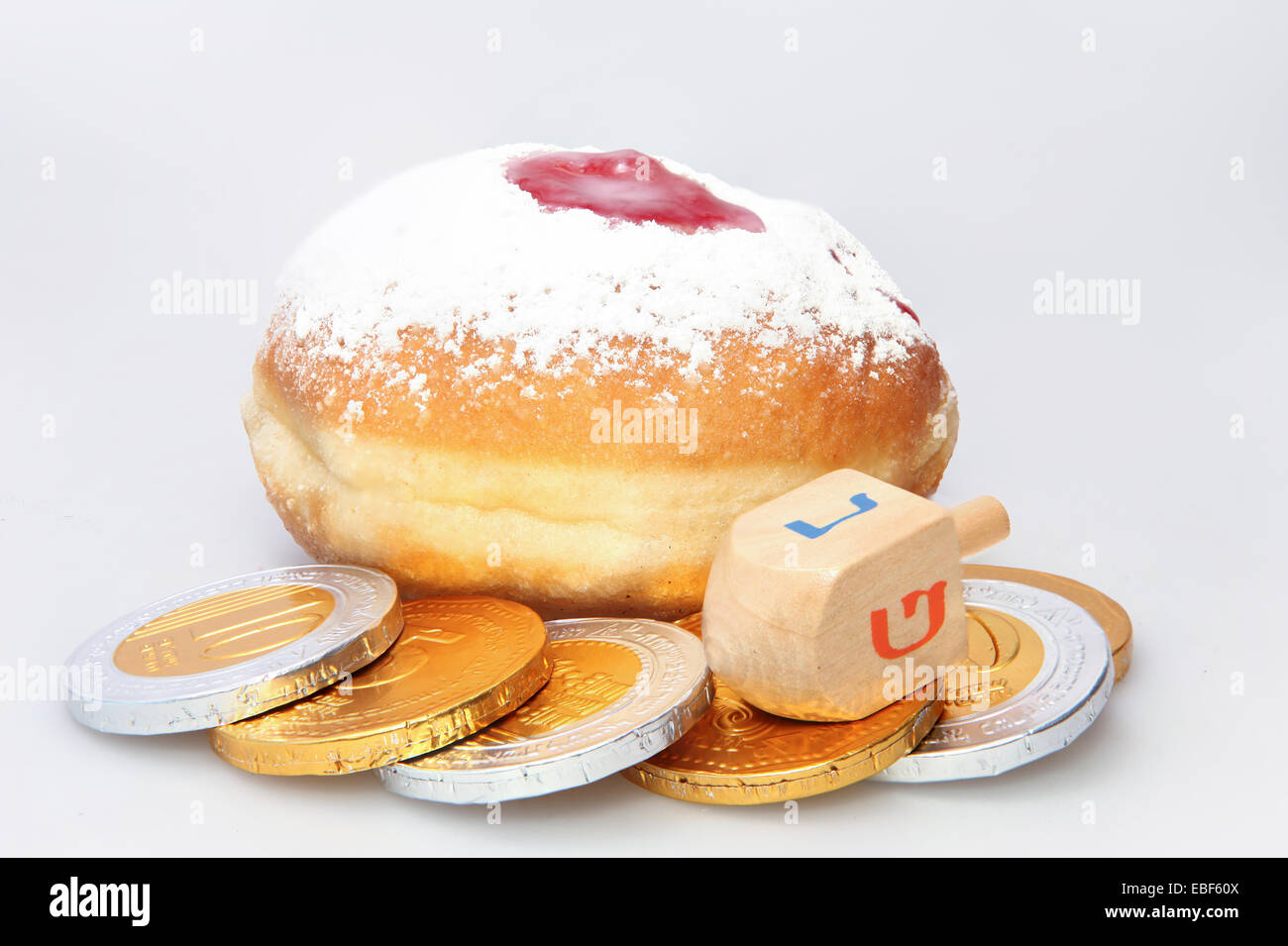 Hanukkah doughnut and spinning top - Traditional jewish holiday food and toy. Stock Photo