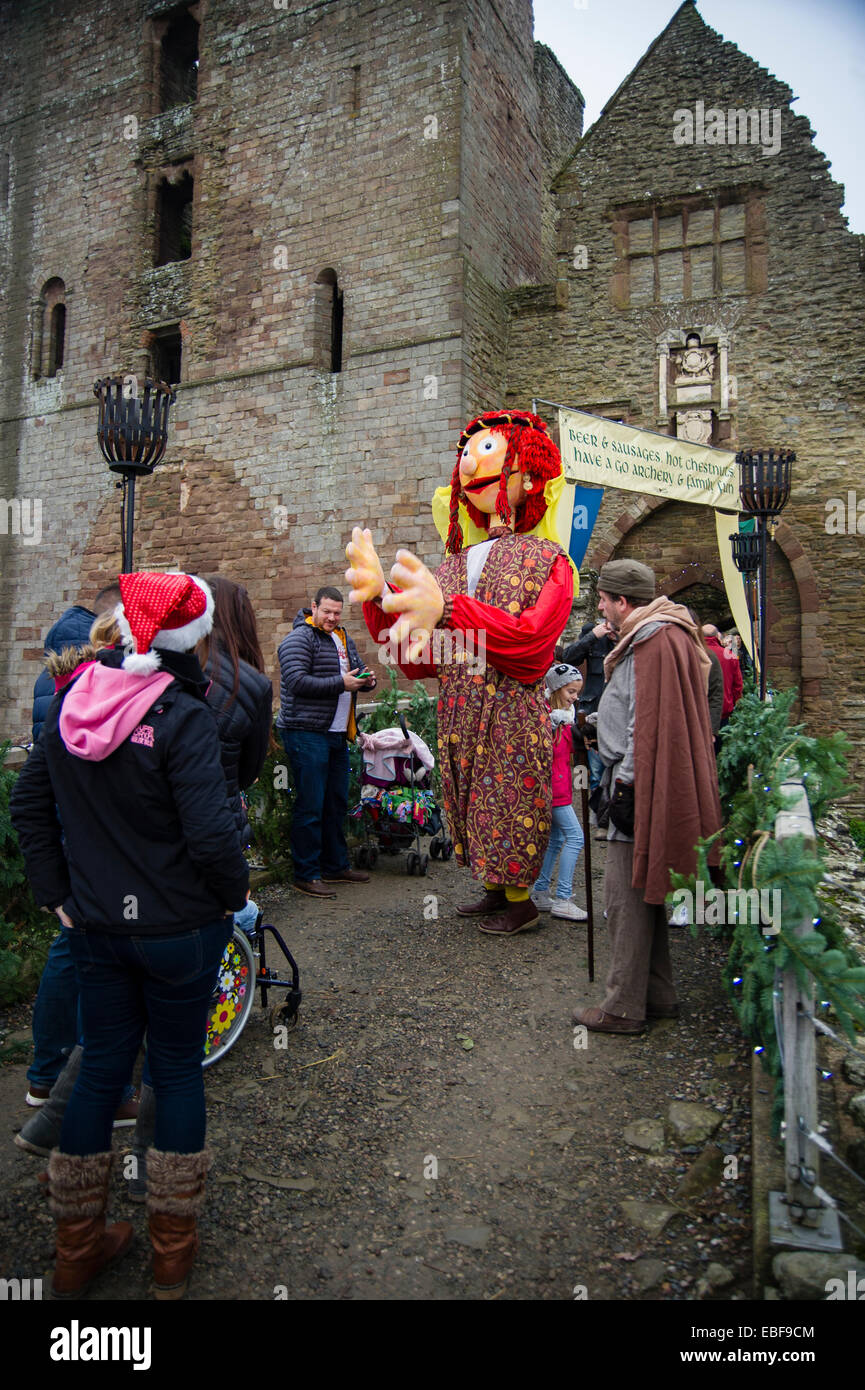 A man and puppet dressed in meieval costume entertaining the public at Ludlow castle Christmas food and craft fair. Shropshire Stock Photo
