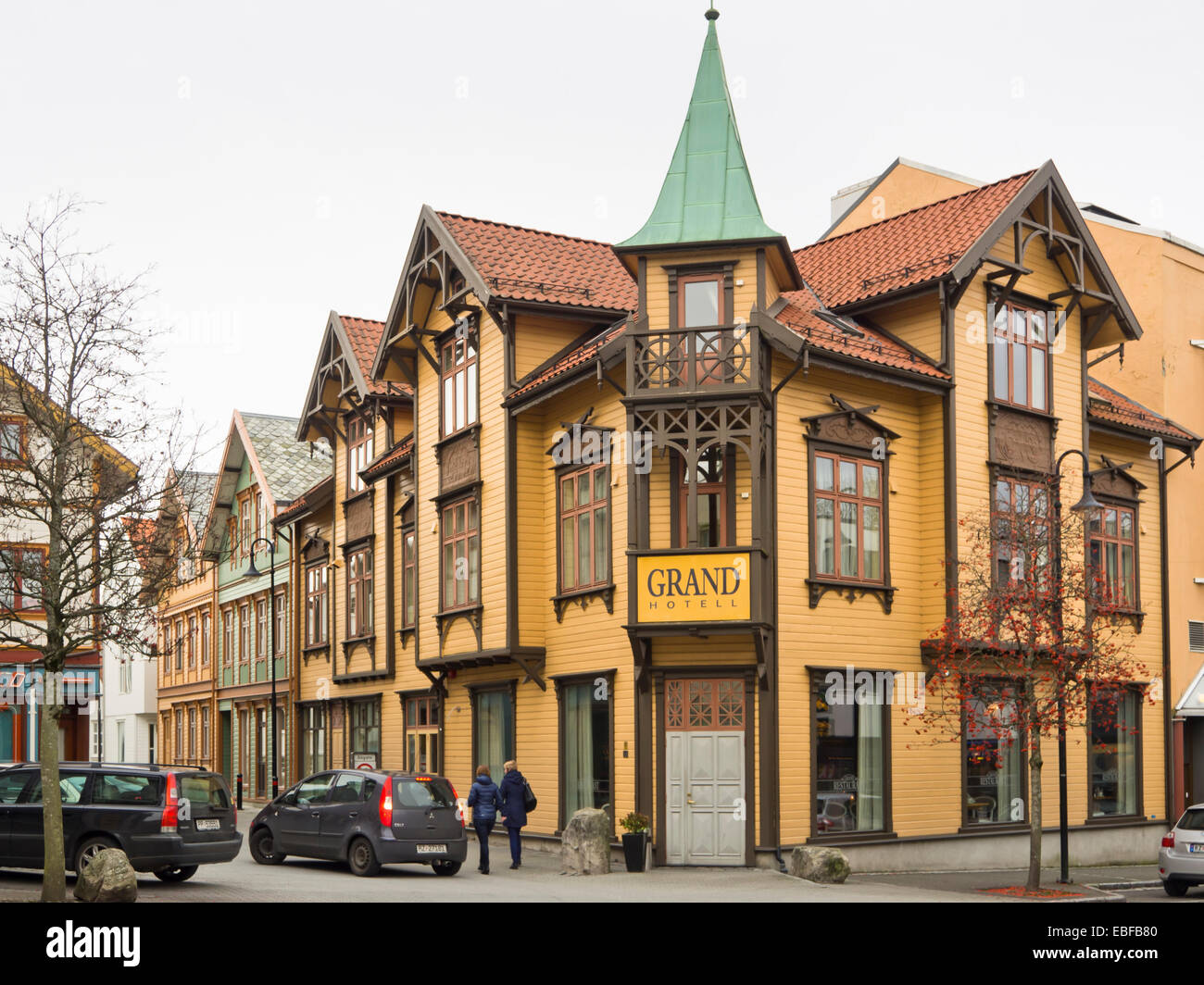 Street corner in the center of the small Norwegian town Egersund, wooden paneled colourful yellow Grand hotell Stock Photo