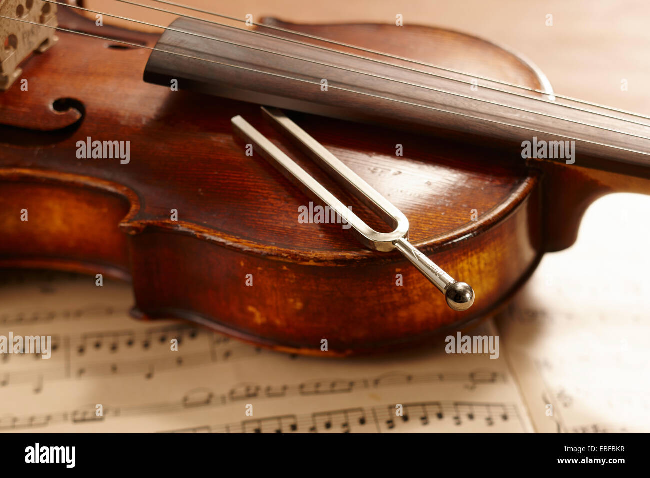 Violin, musical notes and tuning fork lying on violin Stock Photo - Alamy