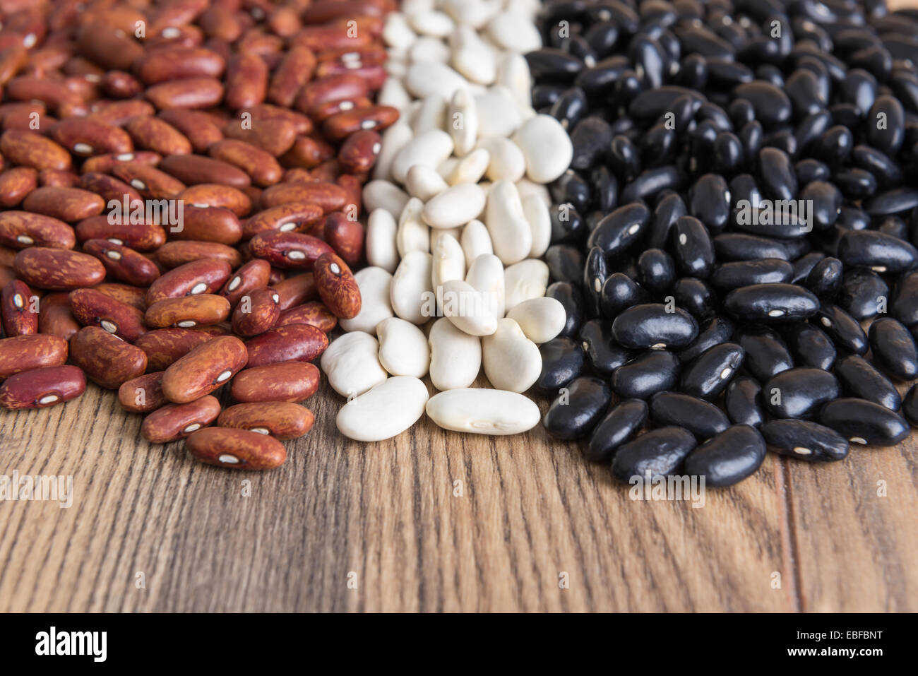 multicolored grains beans on wooden table Stock Photo