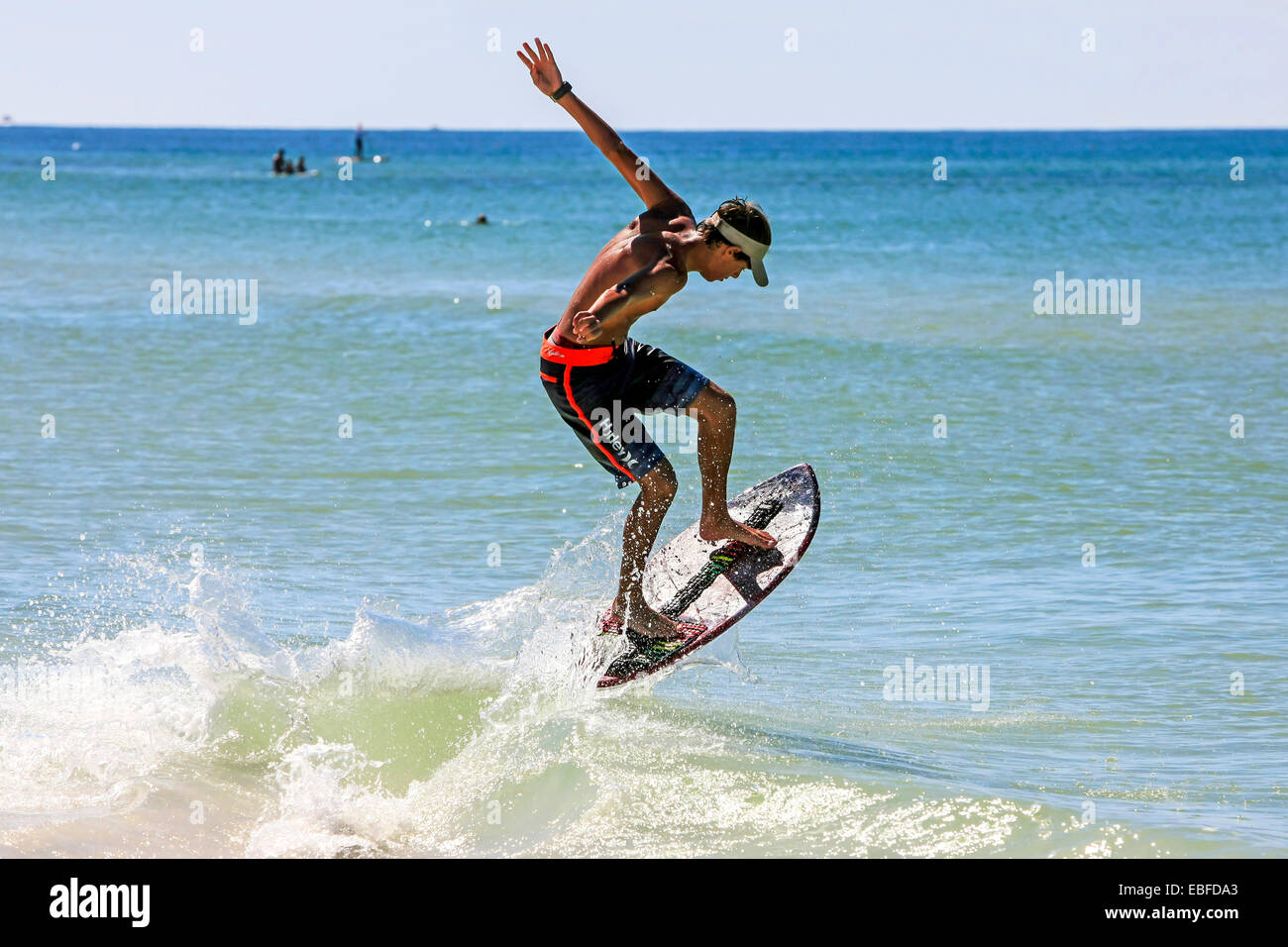 Young teenage boy wakesurfing along Crescent beach on Siesta Key Island Sarasota FL Stock Photo