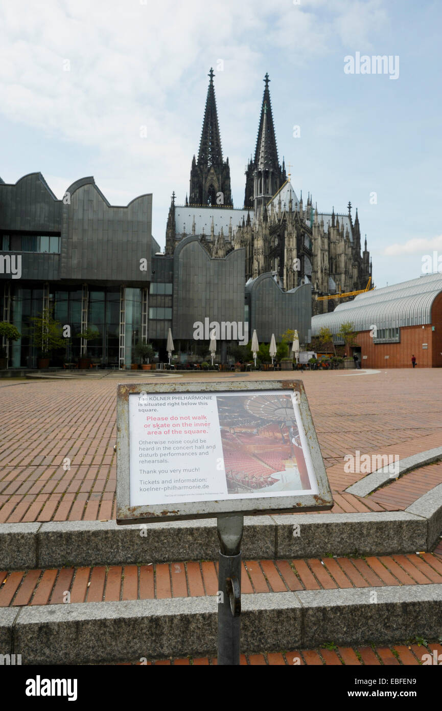 Sign prohibits walking or rollerskating on Heinrich Böll place behind the cathedral on top of the Philharmonic during rehearsals Stock Photo