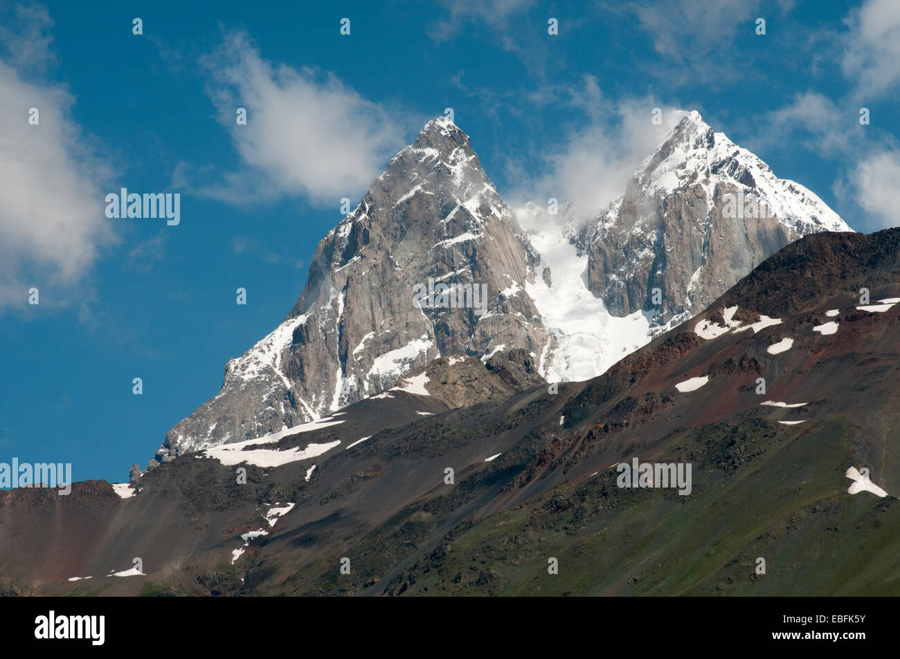 The Ushba mountain is situated against the blue sky background Stock Photo  - Alamy, image size:1300x953
