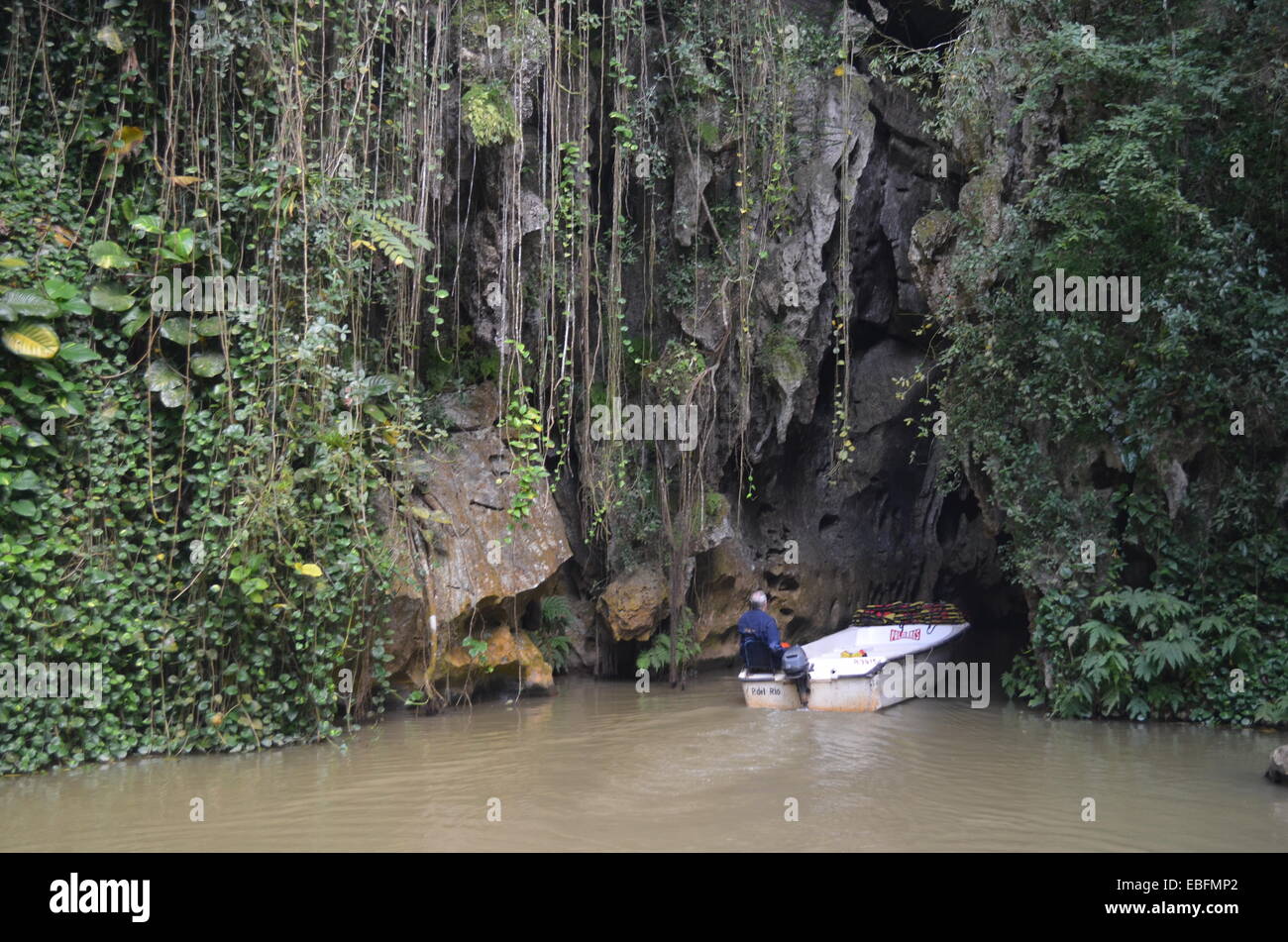 A boat heads into the Cueva del Indio, a tourist attraction in the Vinales region of Cuba Stock Photo