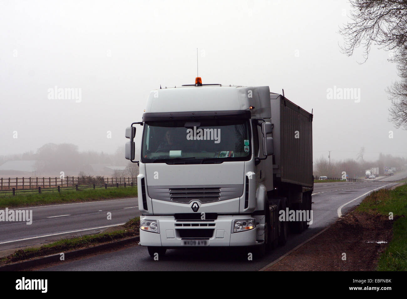 An unmarked articulated Renault truck traveling into a layby on the A417 dual carriageway in The Cotswolds, England Stock Photo