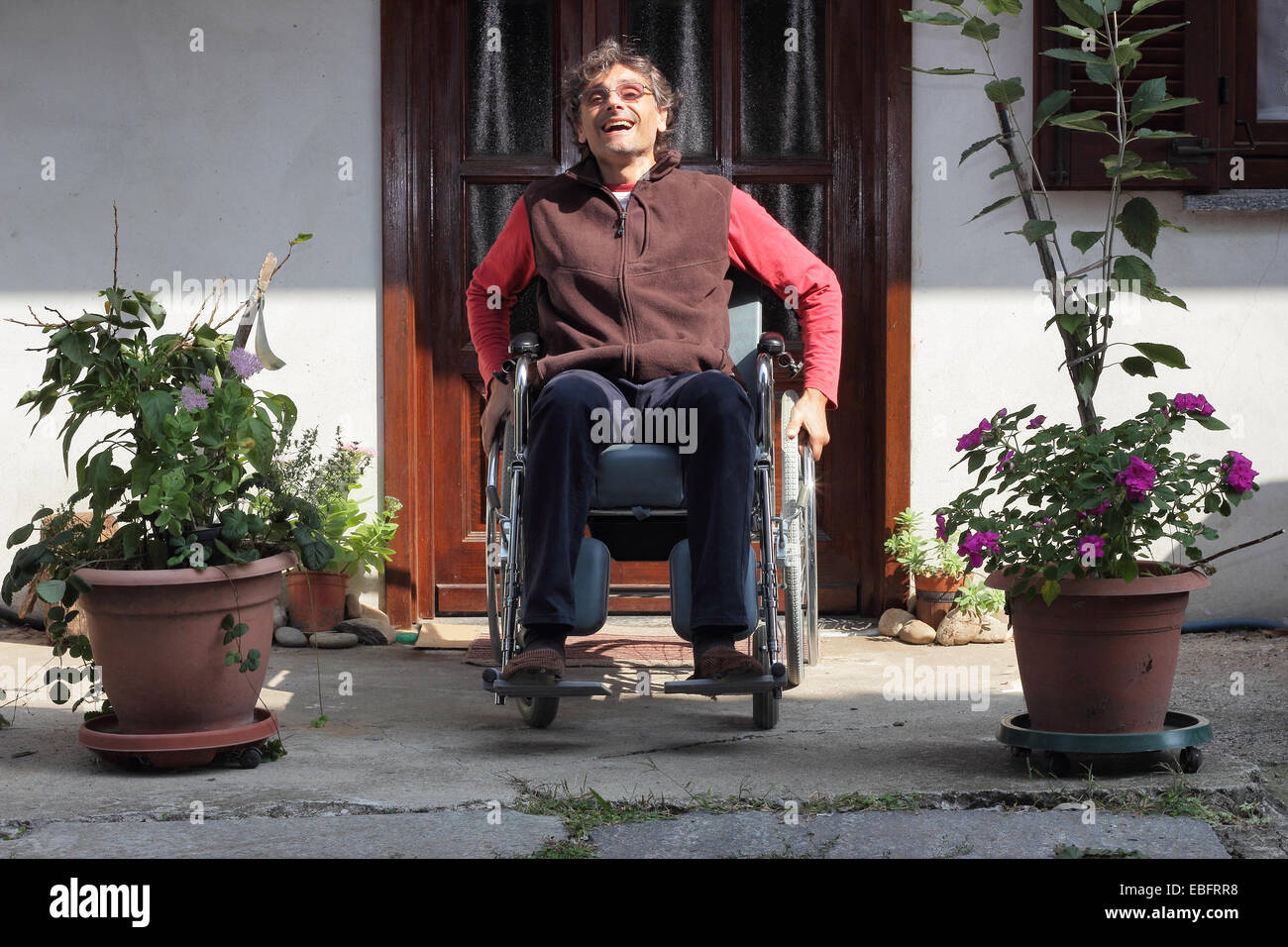 Man in a wheelchair hi-res stock photography and images - Alamy