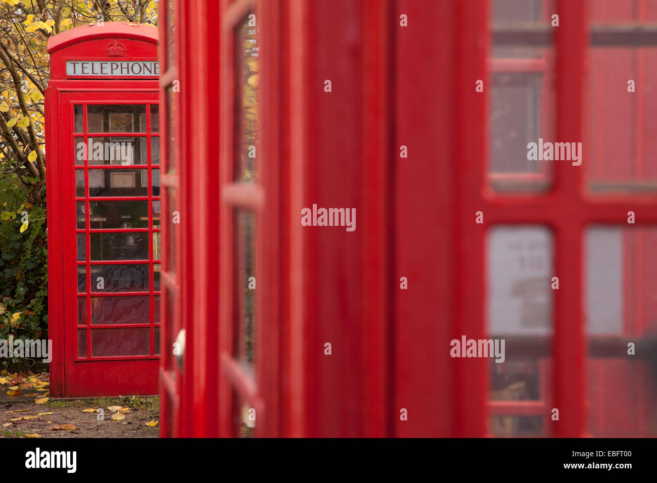 Red telephone boxes as symbols of British Telecom phones prevalent before the rise of mobile technology Stock Photo