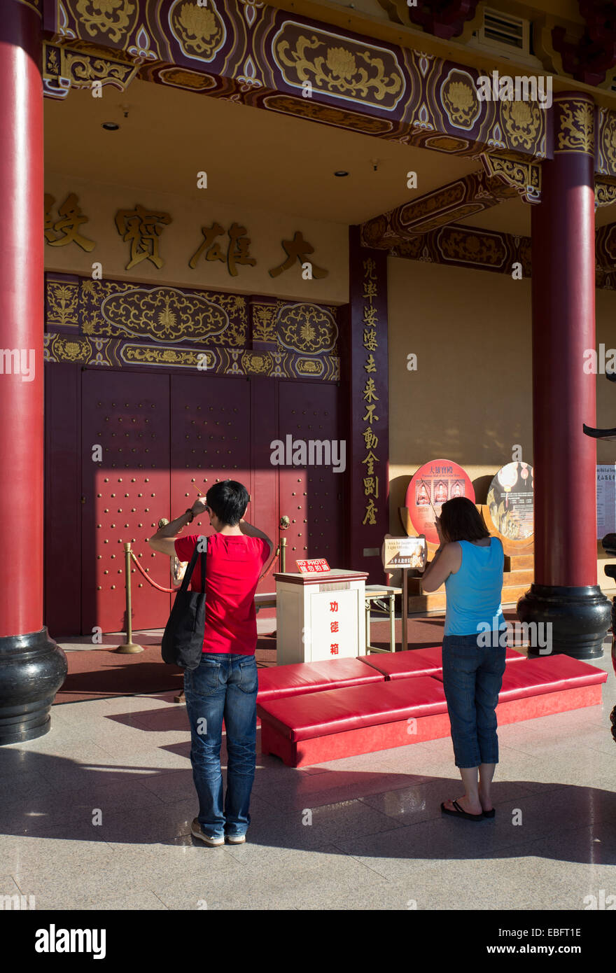 people, adult woman, adult, woman, at prayer, praying, entrance, Main Hall, Hsi Lai Temple, city of Hacienda Heights, Los Angeles County, California Stock Photo