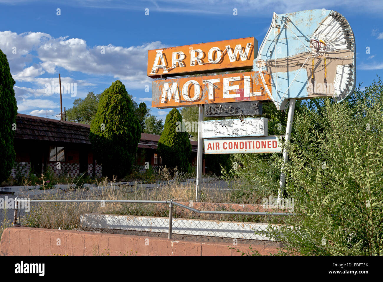 The faded and broken neon sign for the closed Arrow Motel in Espanola, New Mexico. Stock Photo