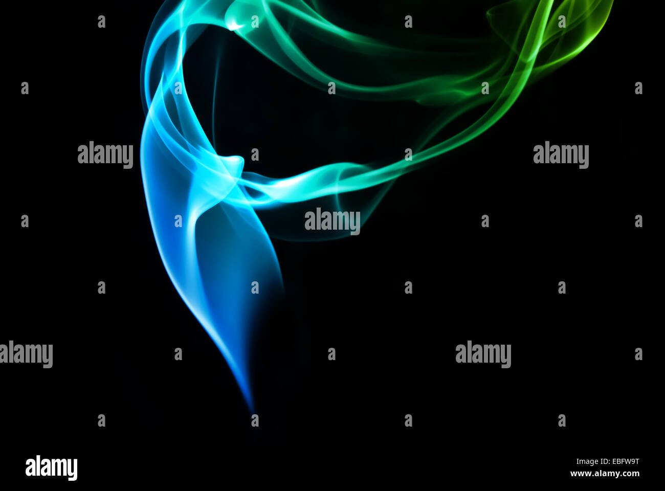 Abstract blue and green smoke on a dark background Stock Photo - Alamy