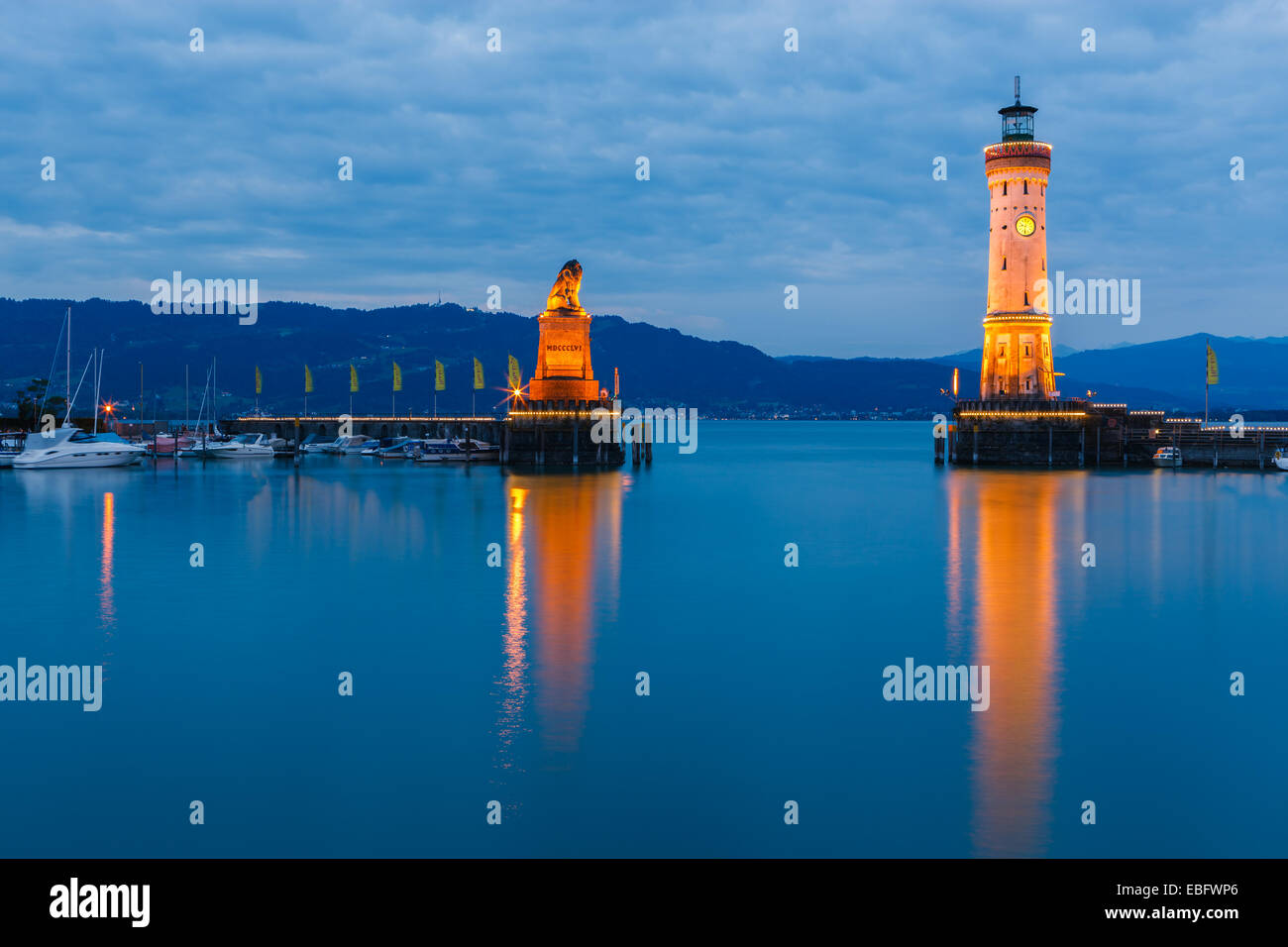 View of harbor entrance and lighthouse at night in Lindau at lake Constance, Bavaria, Germany Stock Photo