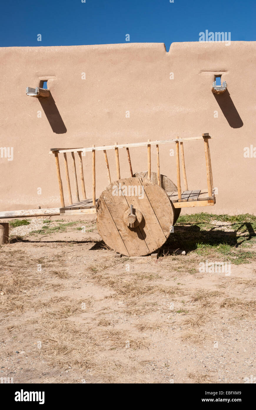 Old wooden cart at adobe walls Stock Photo