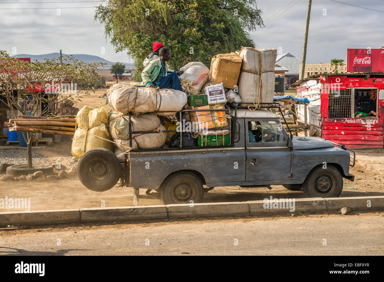 African men transporting goods in an old car Stock Photo