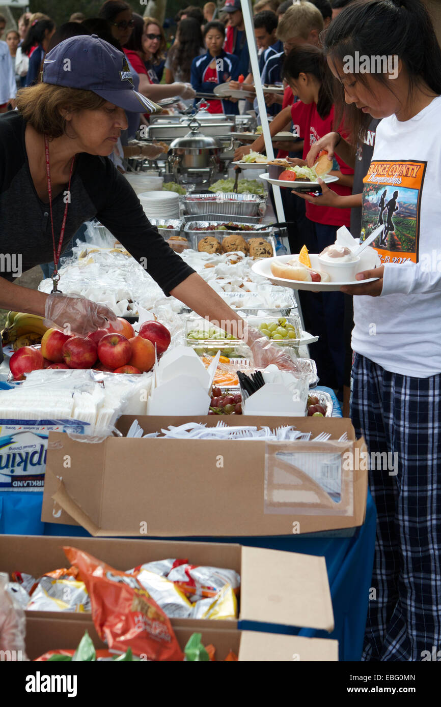 Parents and helpers serve a Picnic in a Park to high school children at the Orange County cross country championships in 2014 Stock Photo