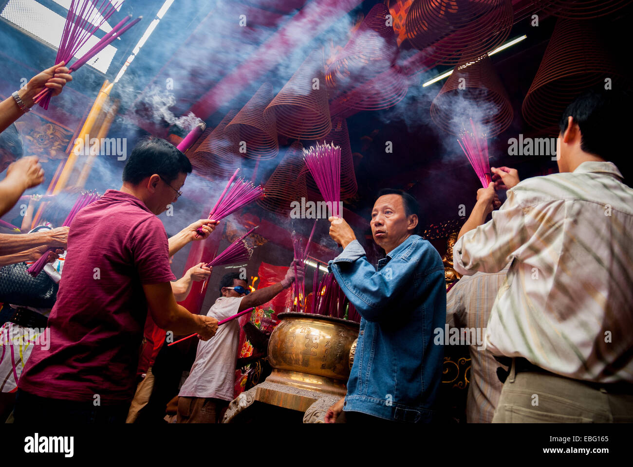 People burning joss sticks (incense sticks) during Chinese New Year