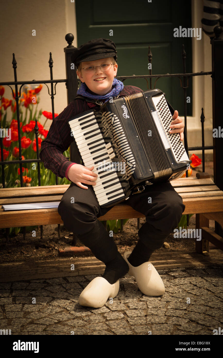 Boy in Dutch clothing playing accordion during the Tulip-Time festival. Pella, Iowa. Stock Photo