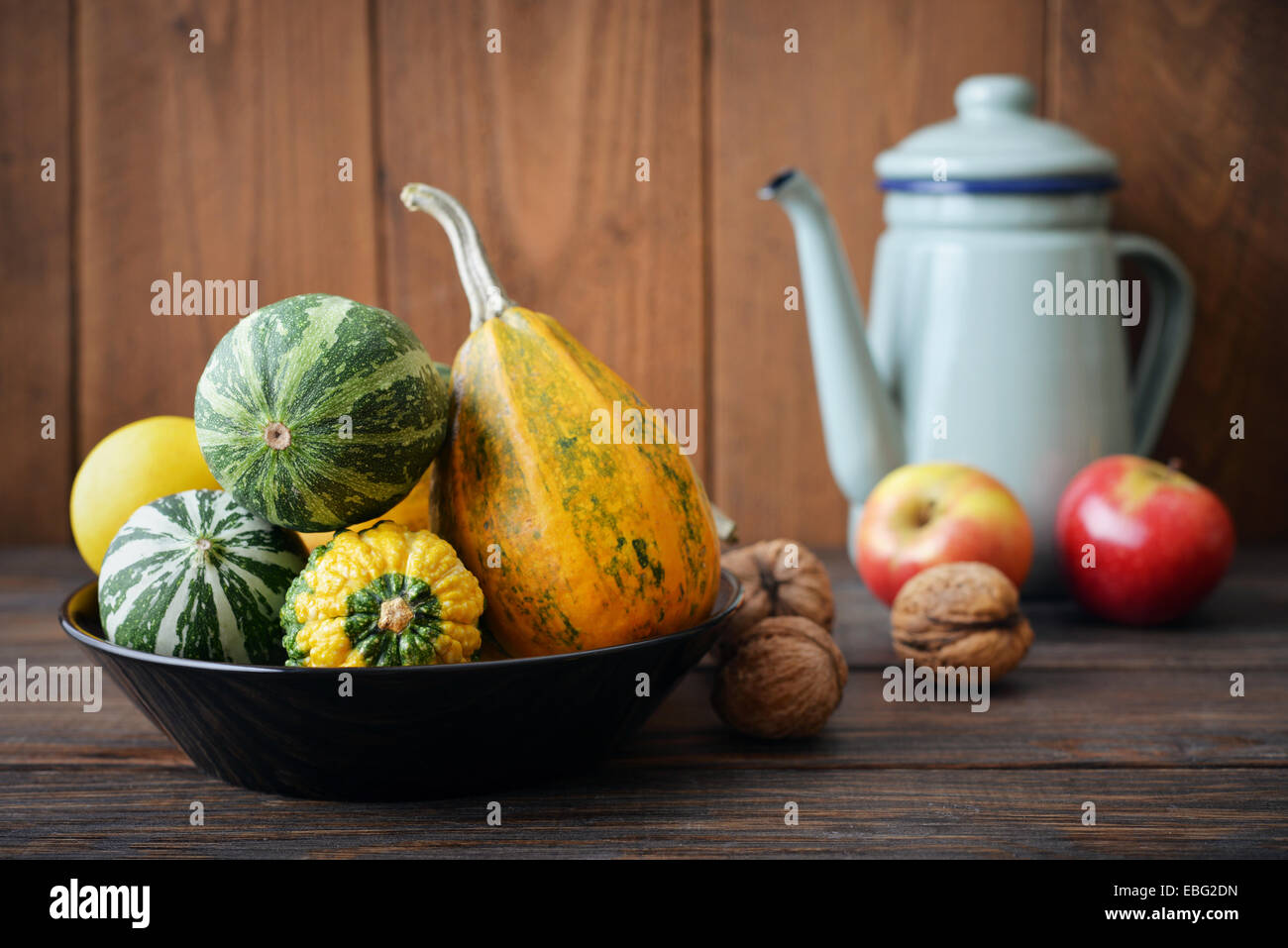 Fresh pumpkins with fruits and vintage kettle on wooden background ...
